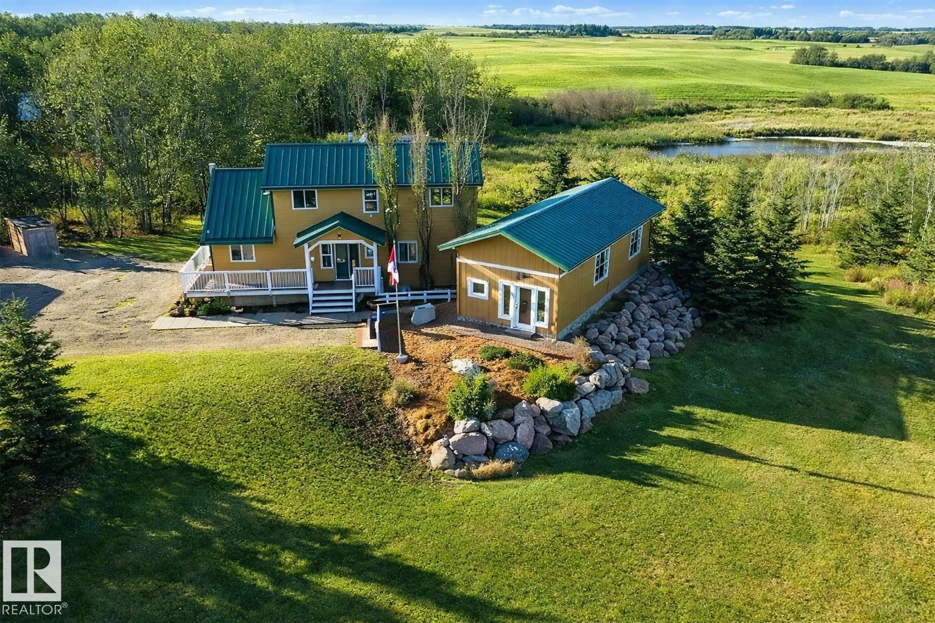 A pic from outside/outdoor area/front of a property/back of a property/a pic from drone, water/lake/river/ocean view for 120 50434 RGE RD 232, Rural Leduc County Alberta T4X0L1