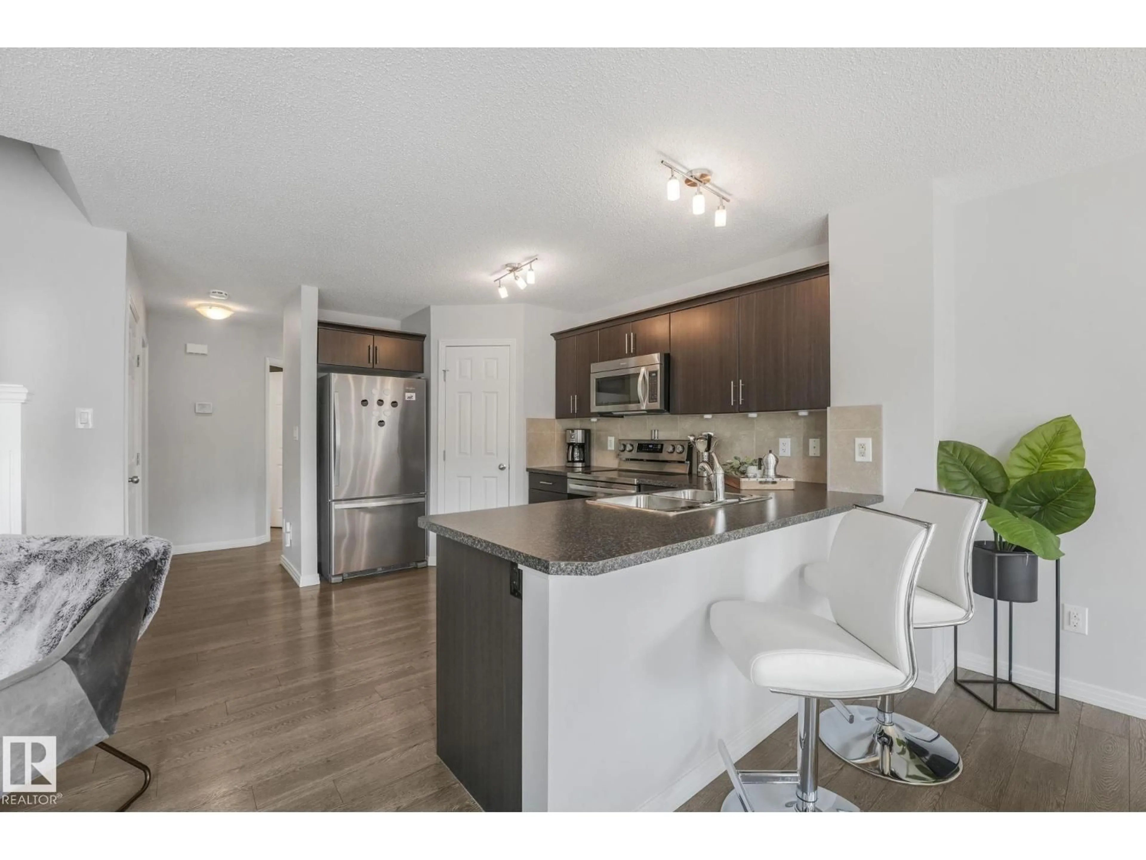 Open concept kitchen, wood/laminate floor for SW - 1126 176 ST, Edmonton Alberta T6W2B7