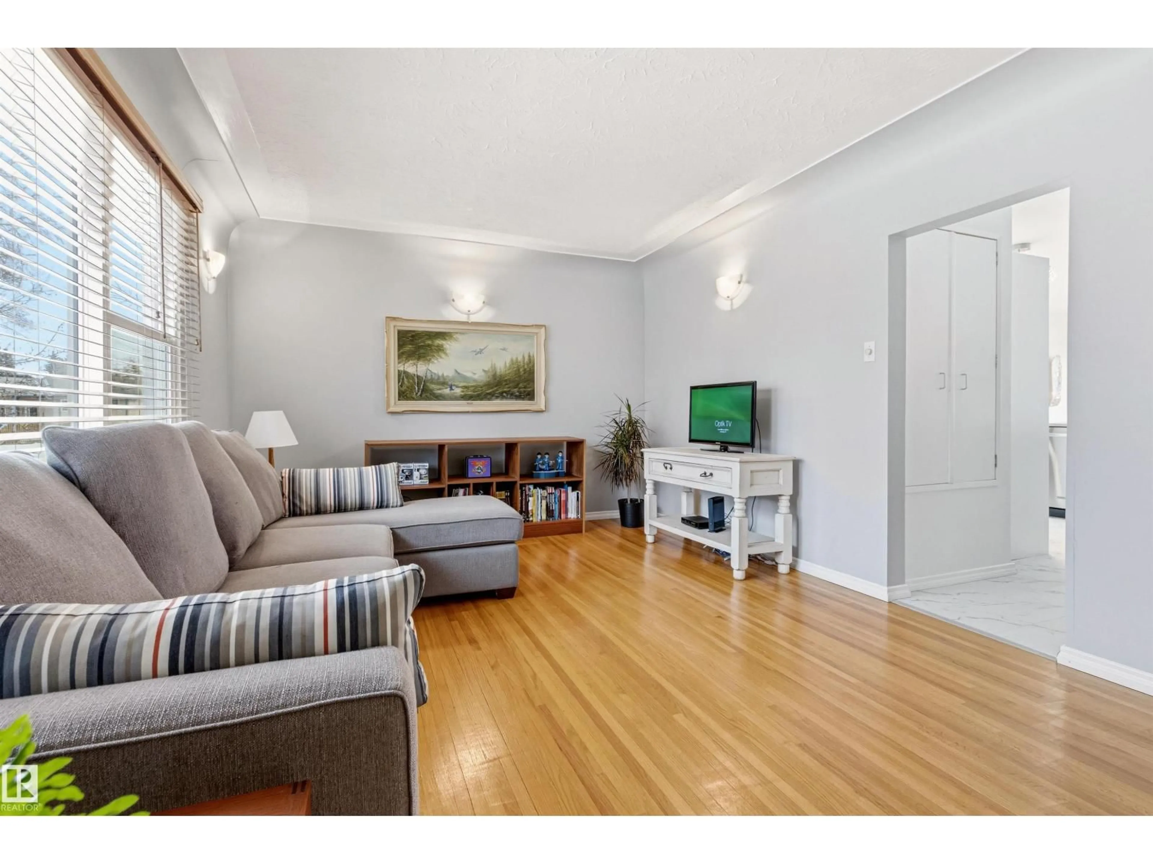 Living room with furniture, wood/laminate floor for 13619 108 AV, Edmonton Alberta T5M2C7