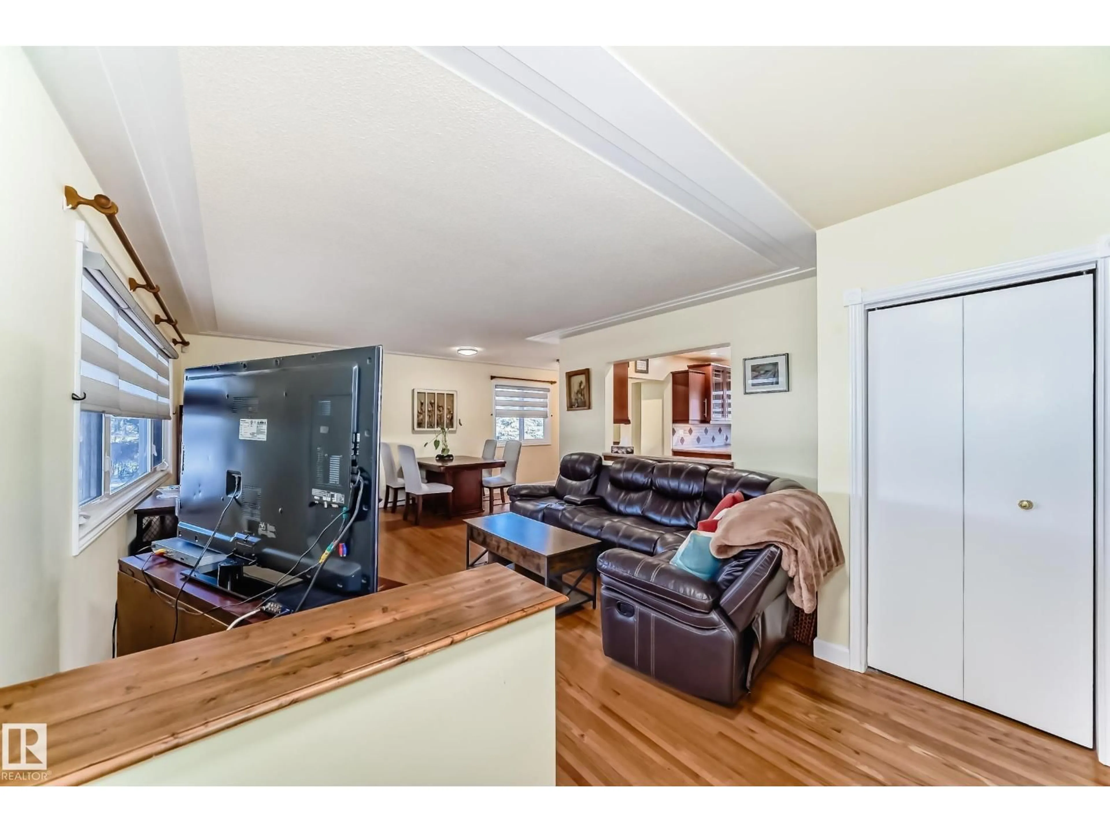 Living room with furniture, wood/laminate floor for 4446 116 AV, Edmonton Alberta T5W0X3