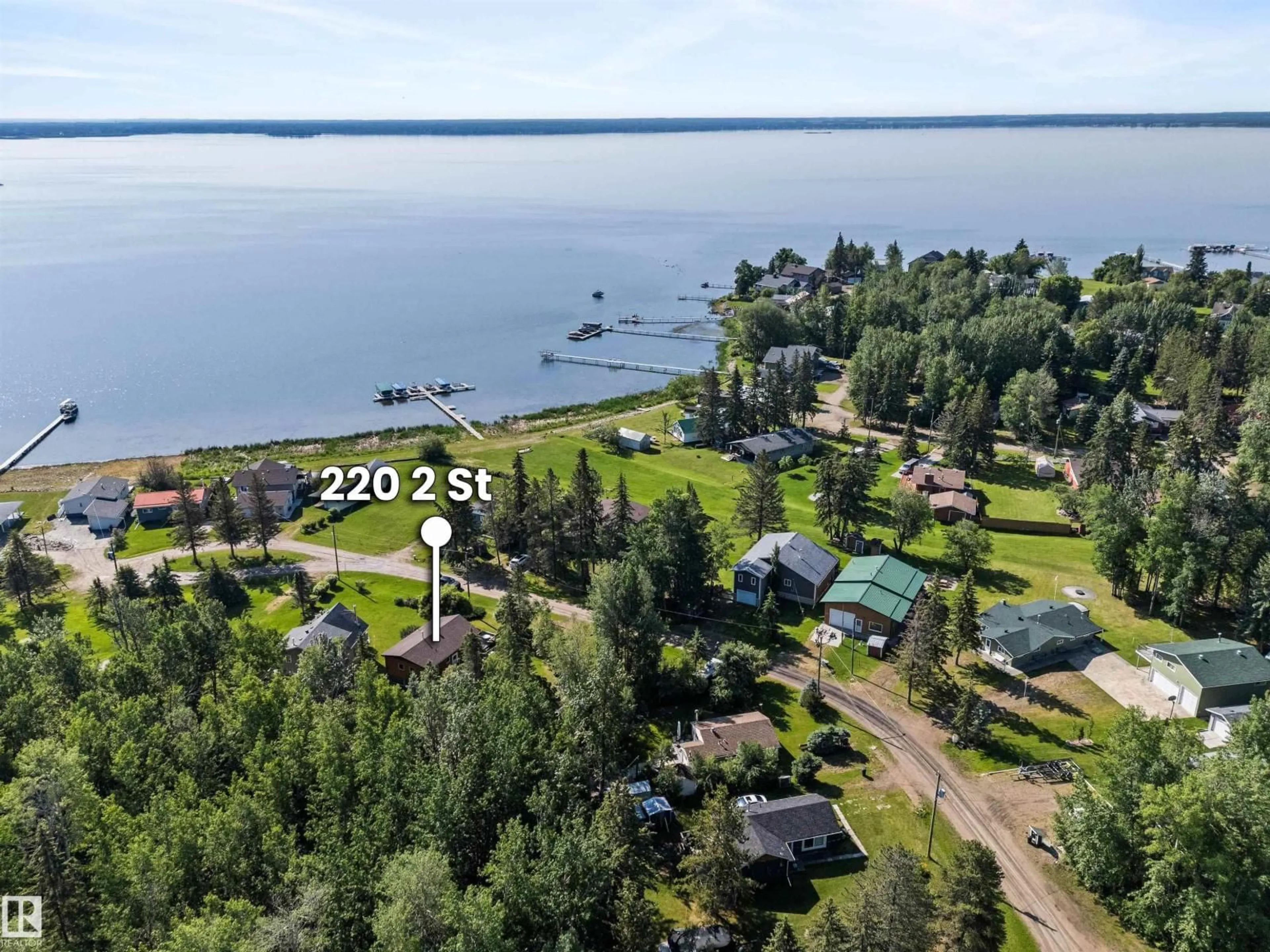A pic from outside/outdoor area/front of a property/back of a property/a pic from drone, water/lake/river/ocean view for 220 2 ST, Rural Lac Ste. Anne County Alberta T0E1A0