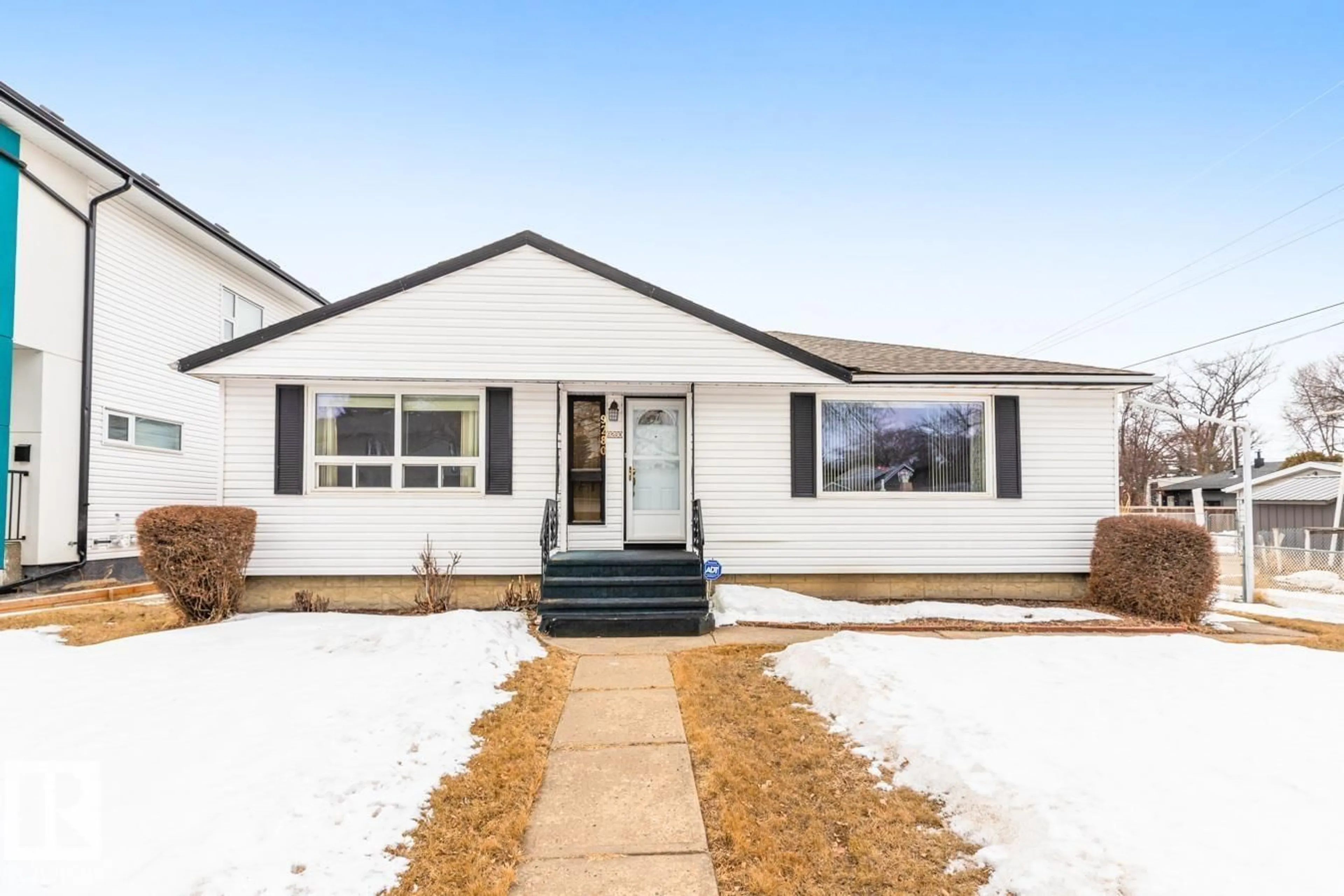 Home with vinyl exterior material, street for 9280 77 ST, Edmonton Alberta T6C2M1