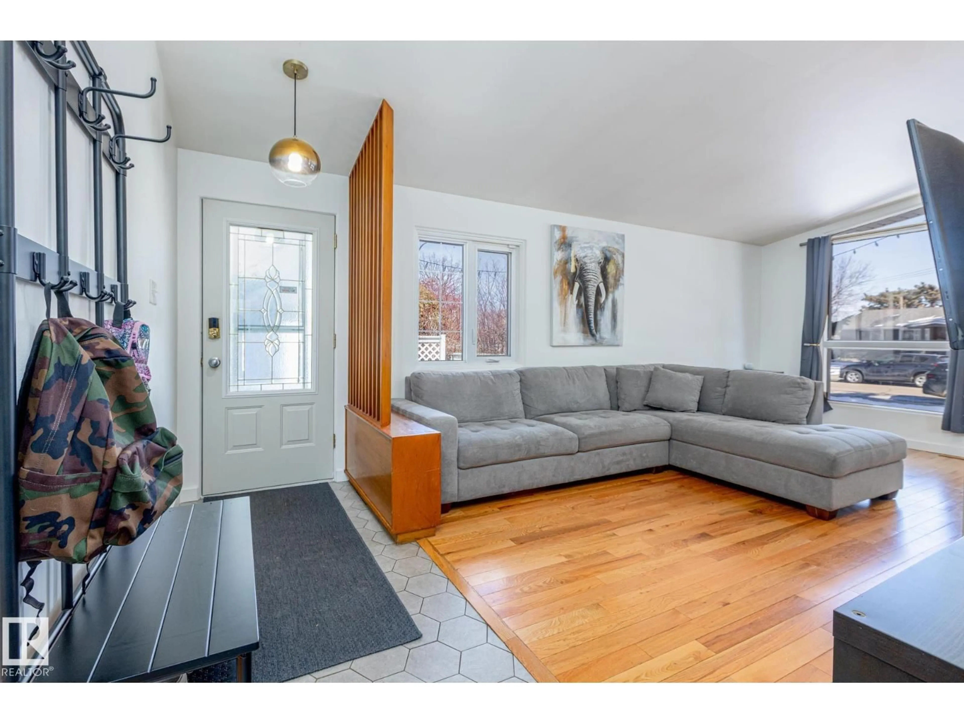 Living room with furniture, wood/laminate floor for 6511 103 AV, Edmonton Alberta T6A0T7