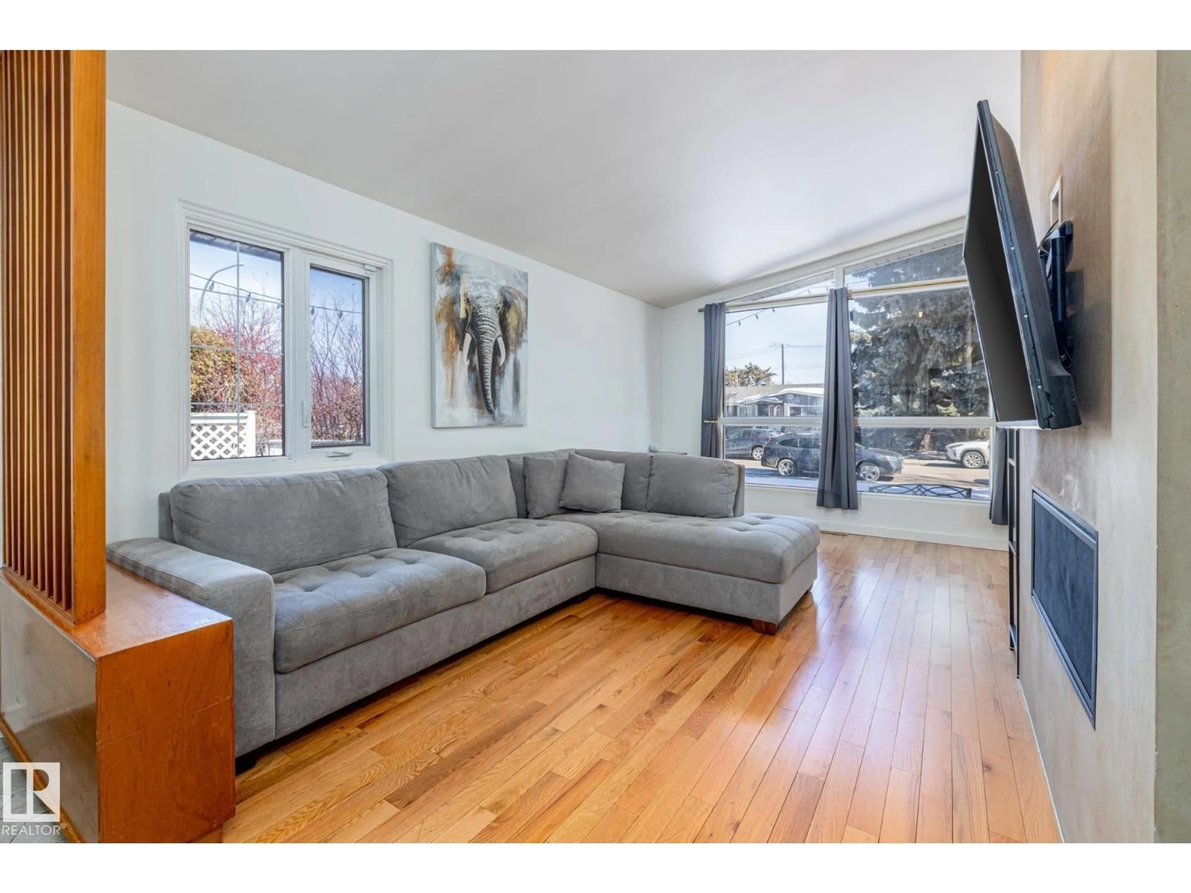 Living room with furniture, wood/laminate floor for 6511 103 AV, Edmonton Alberta T6A0T7