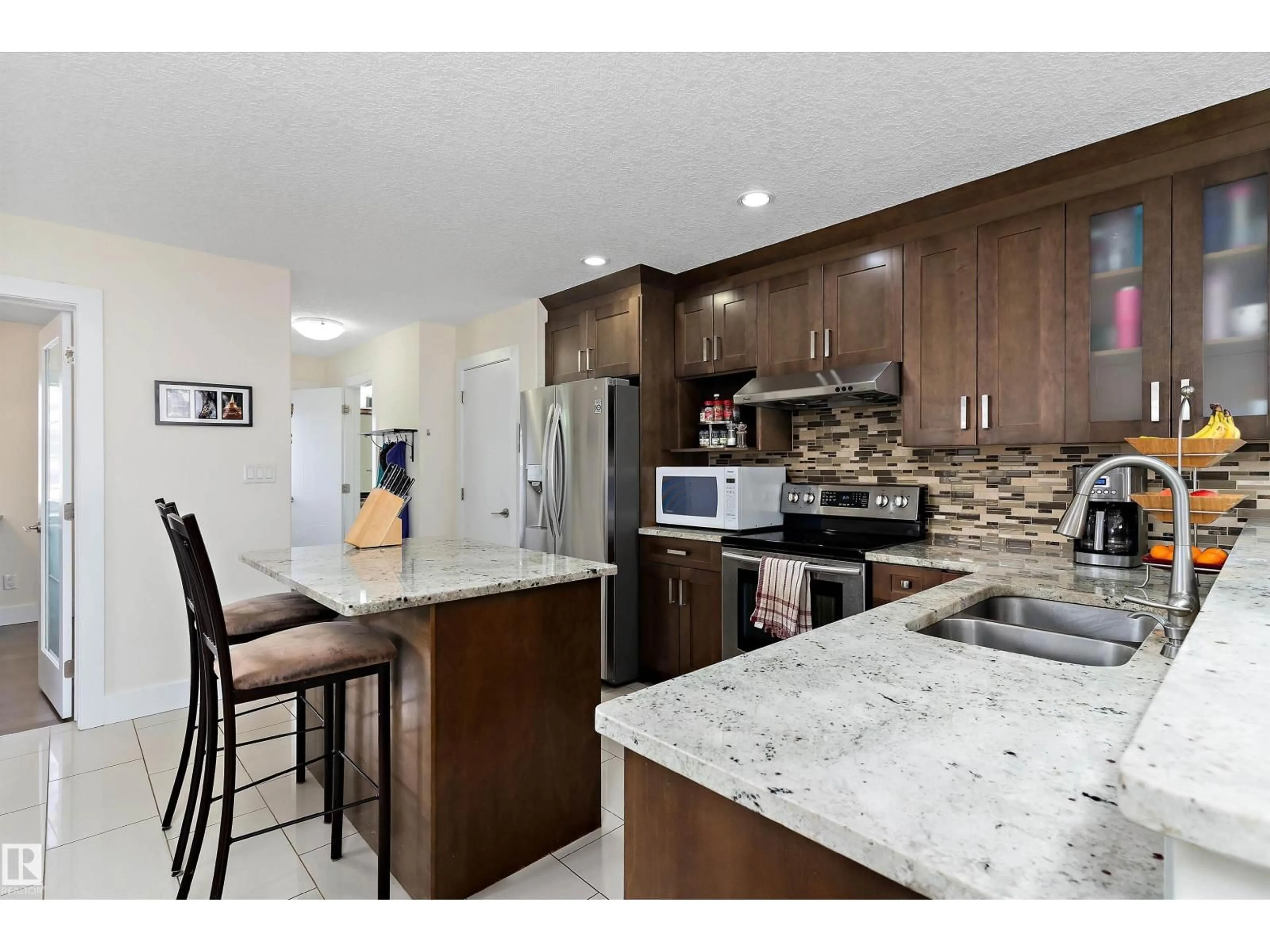 Open concept kitchen, ceramic/tile floor for 8148 77 AV, Edmonton Alberta T6C0L2