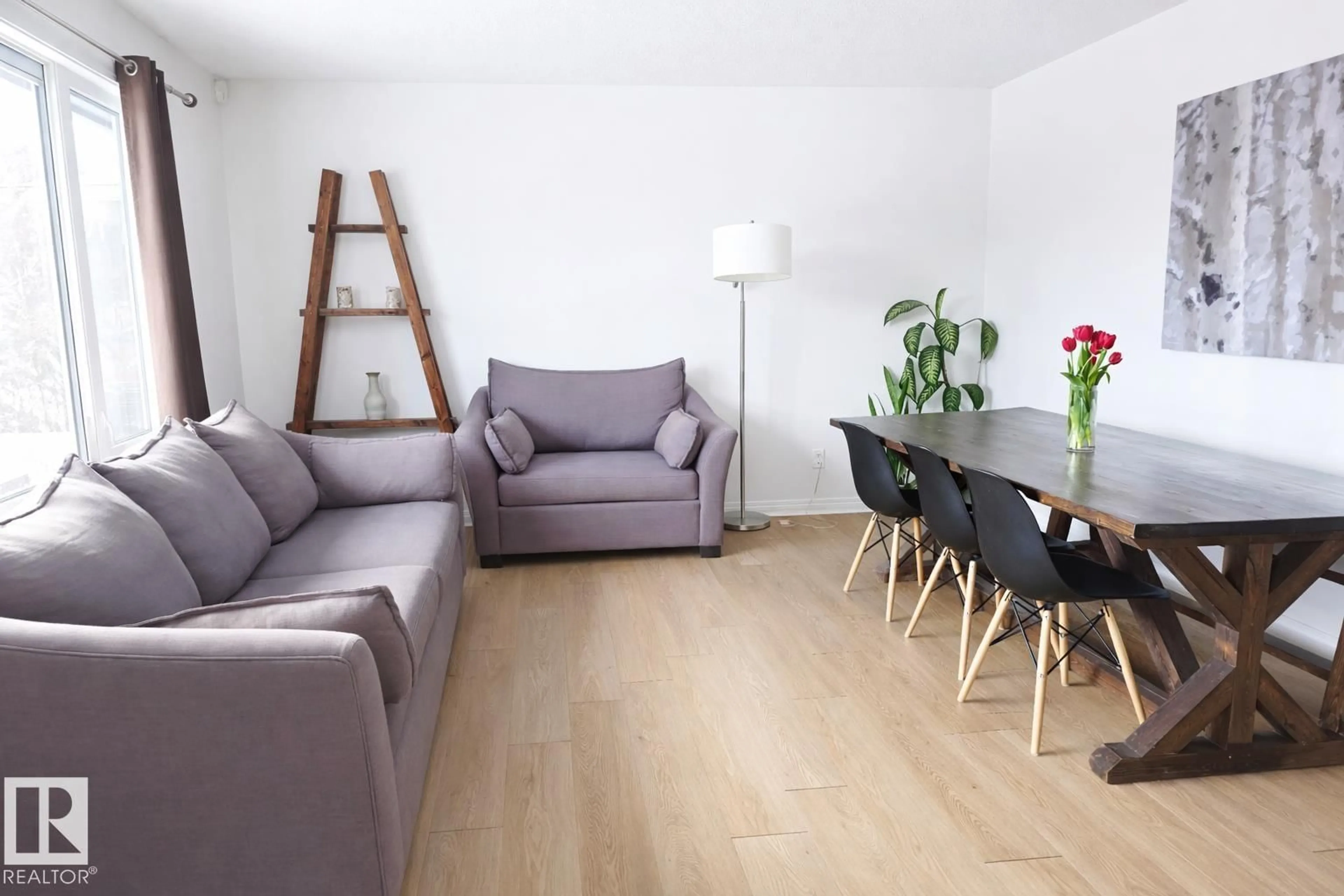 Living room with furniture, wood/laminate floor for NW - 4820 105B ST, Edmonton Alberta T6H2S1