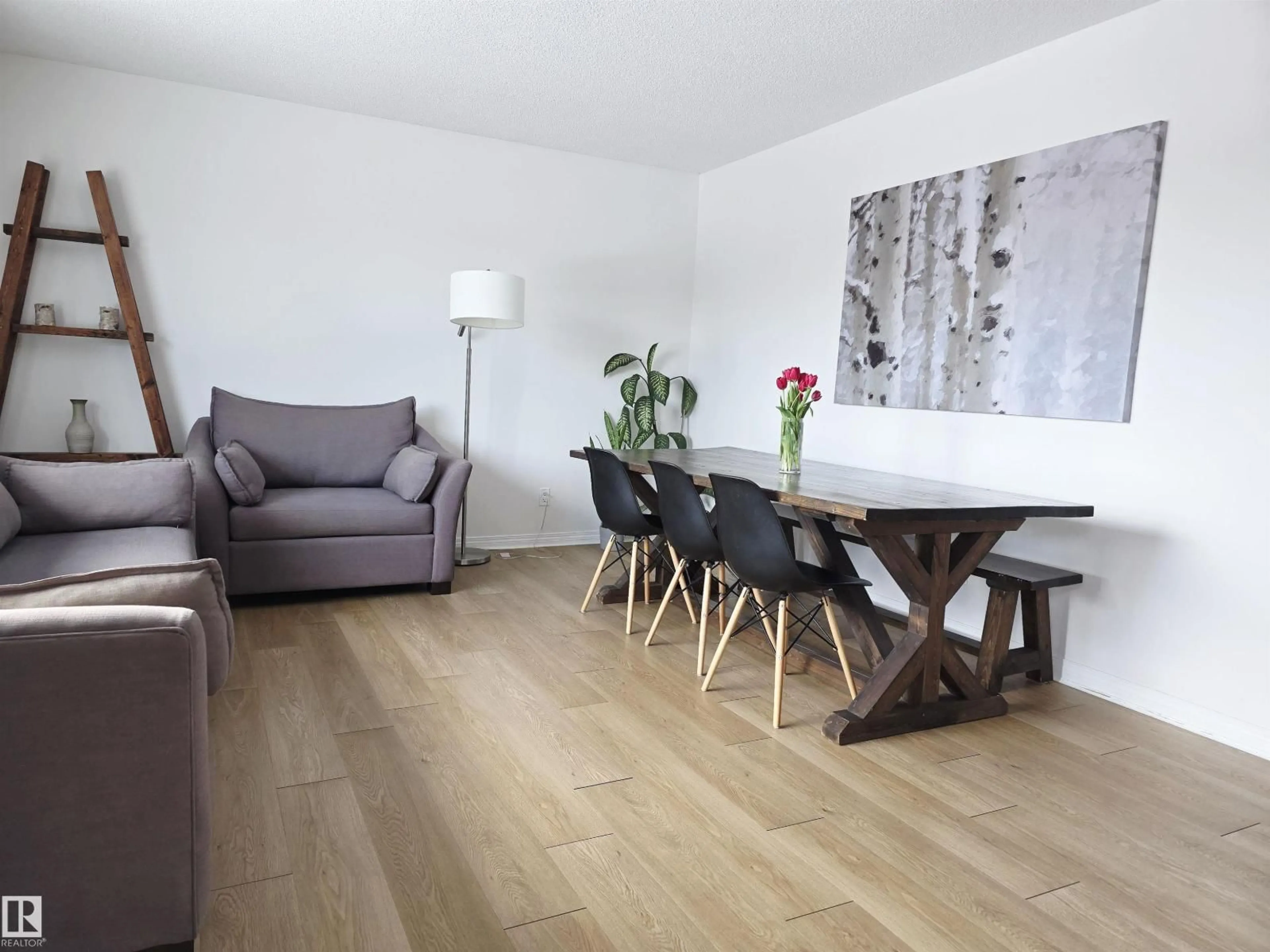 Living room with furniture, wood/laminate floor for NW - 4820 105B ST, Edmonton Alberta T6H2S1