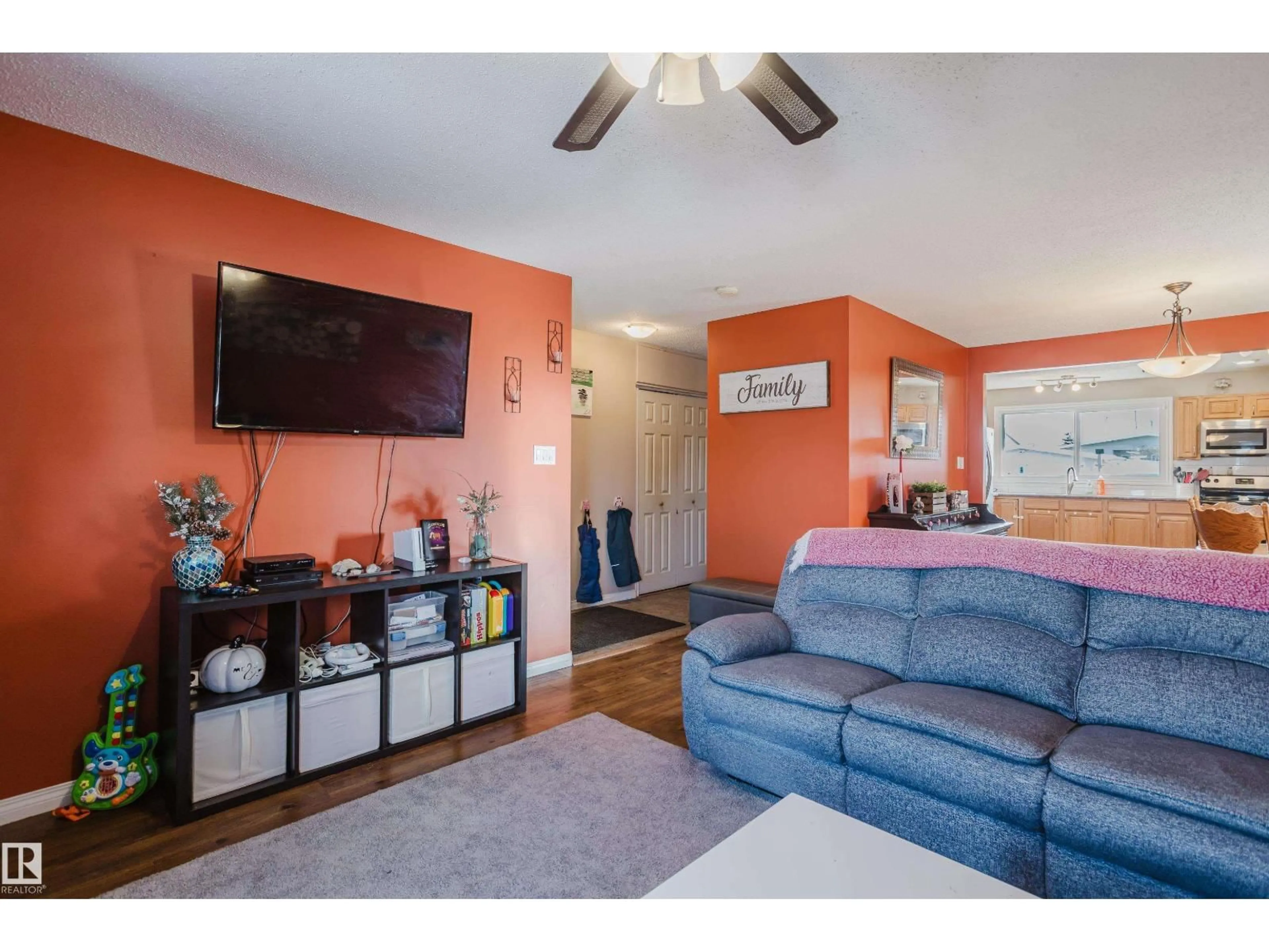 Living room with furniture, wood/laminate floor for NW - 8707 151 AV, Edmonton Alberta T5E5Y1