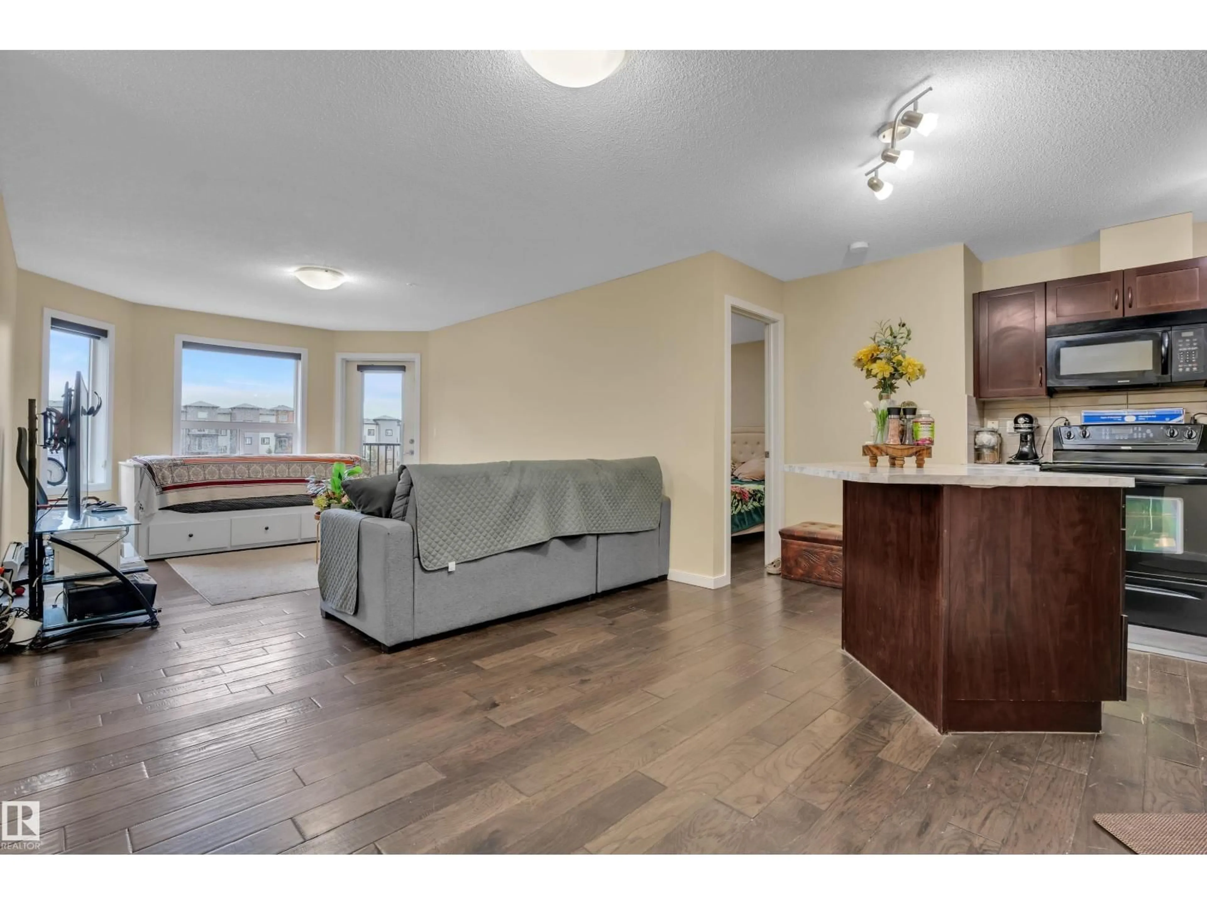 Living room with furniture, wood/laminate floor for #320 - 392 SILVER BERRY RD, Edmonton Alberta T6T0H1