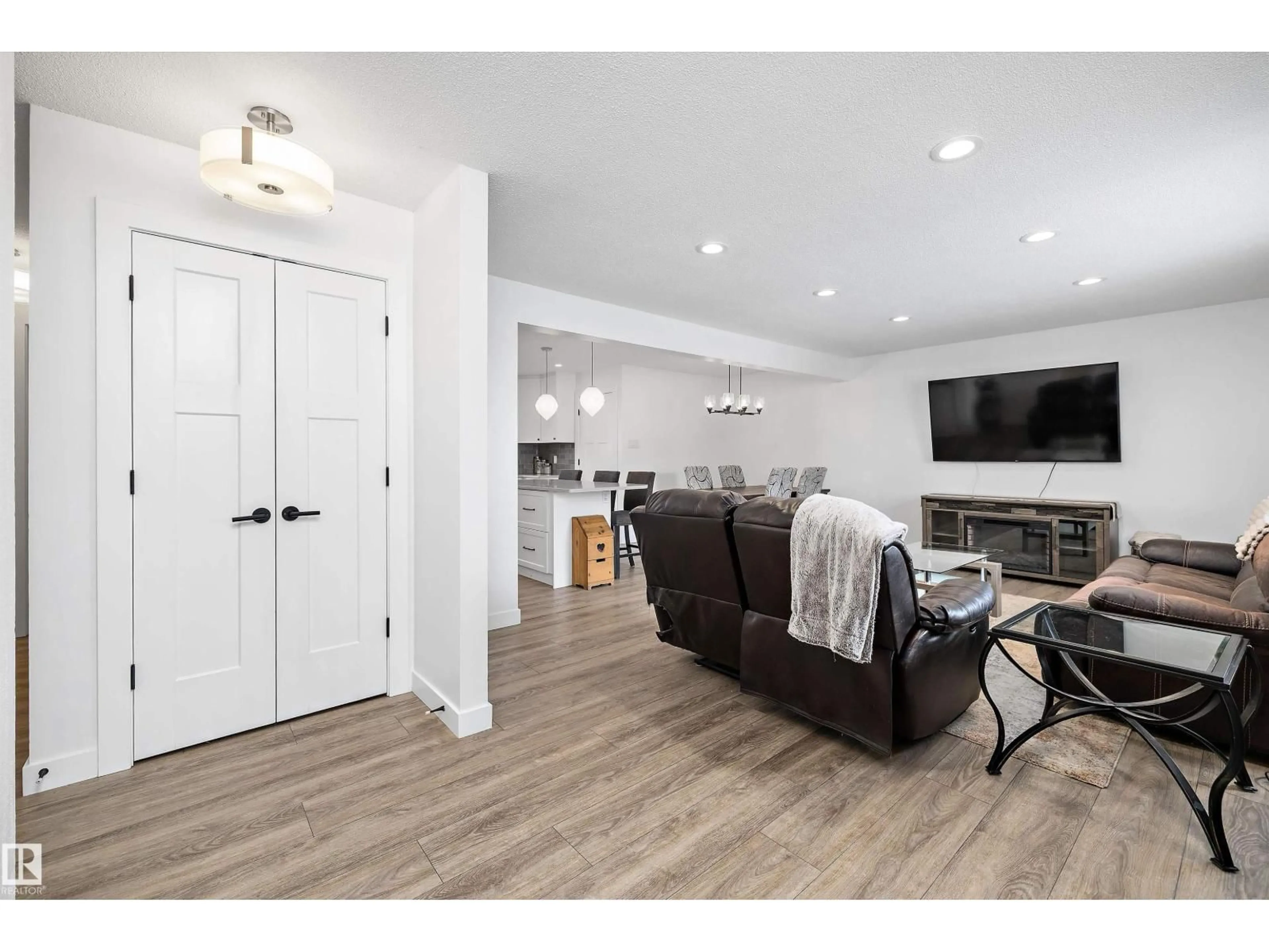 Living room with furniture, wood/laminate floor for 10808 34 ST, Edmonton Alberta T5W1Y4