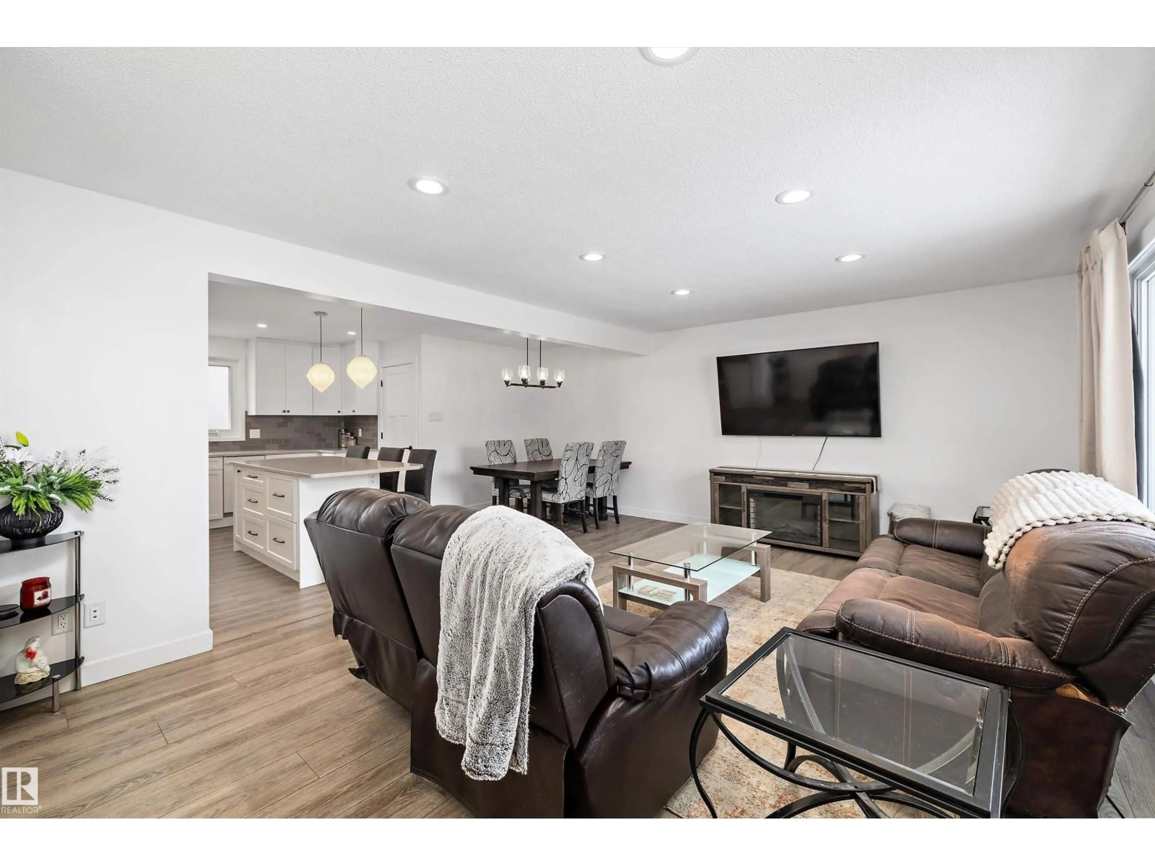 Living room with furniture, wood/laminate floor for 10808 34 ST, Edmonton Alberta T5W1Y4