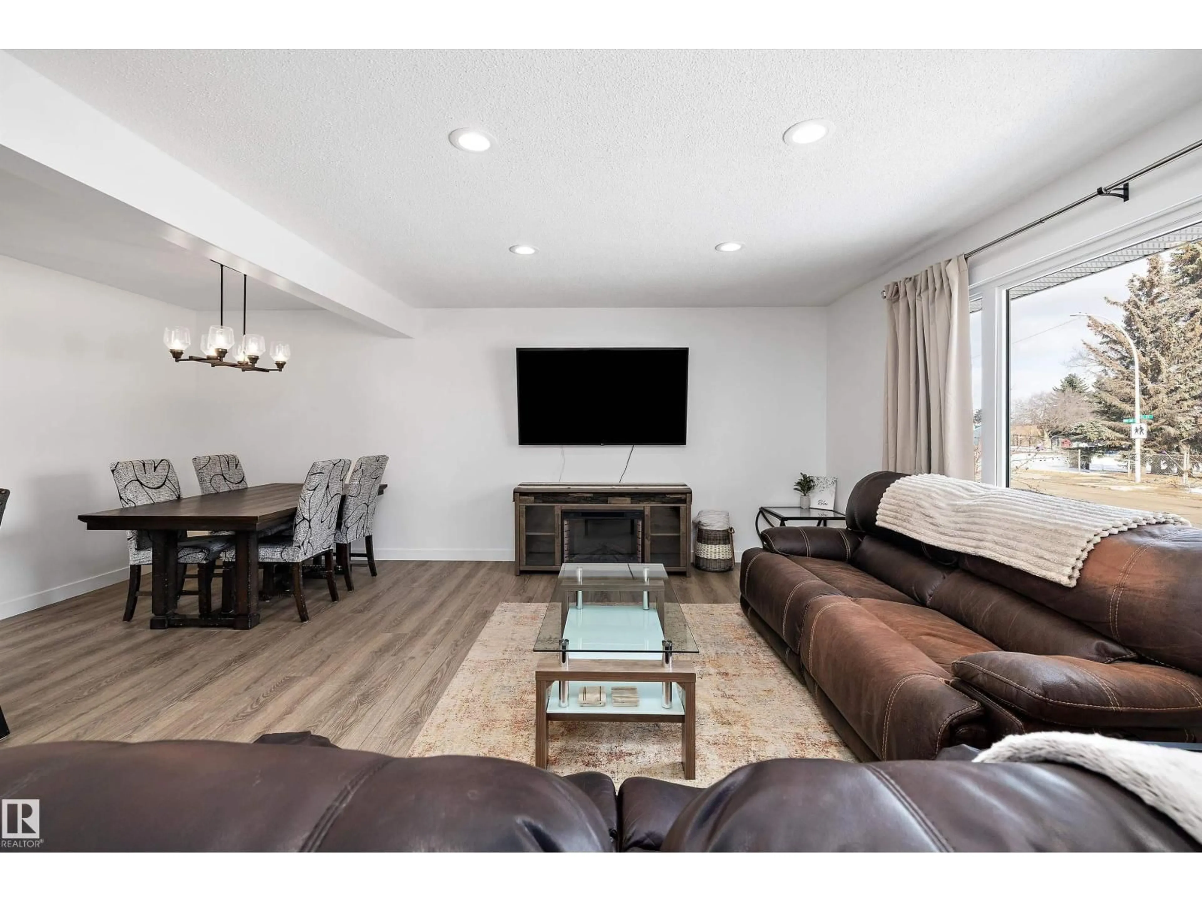 Living room with furniture, wood/laminate floor for 10808 34 ST, Edmonton Alberta T5W1Y4