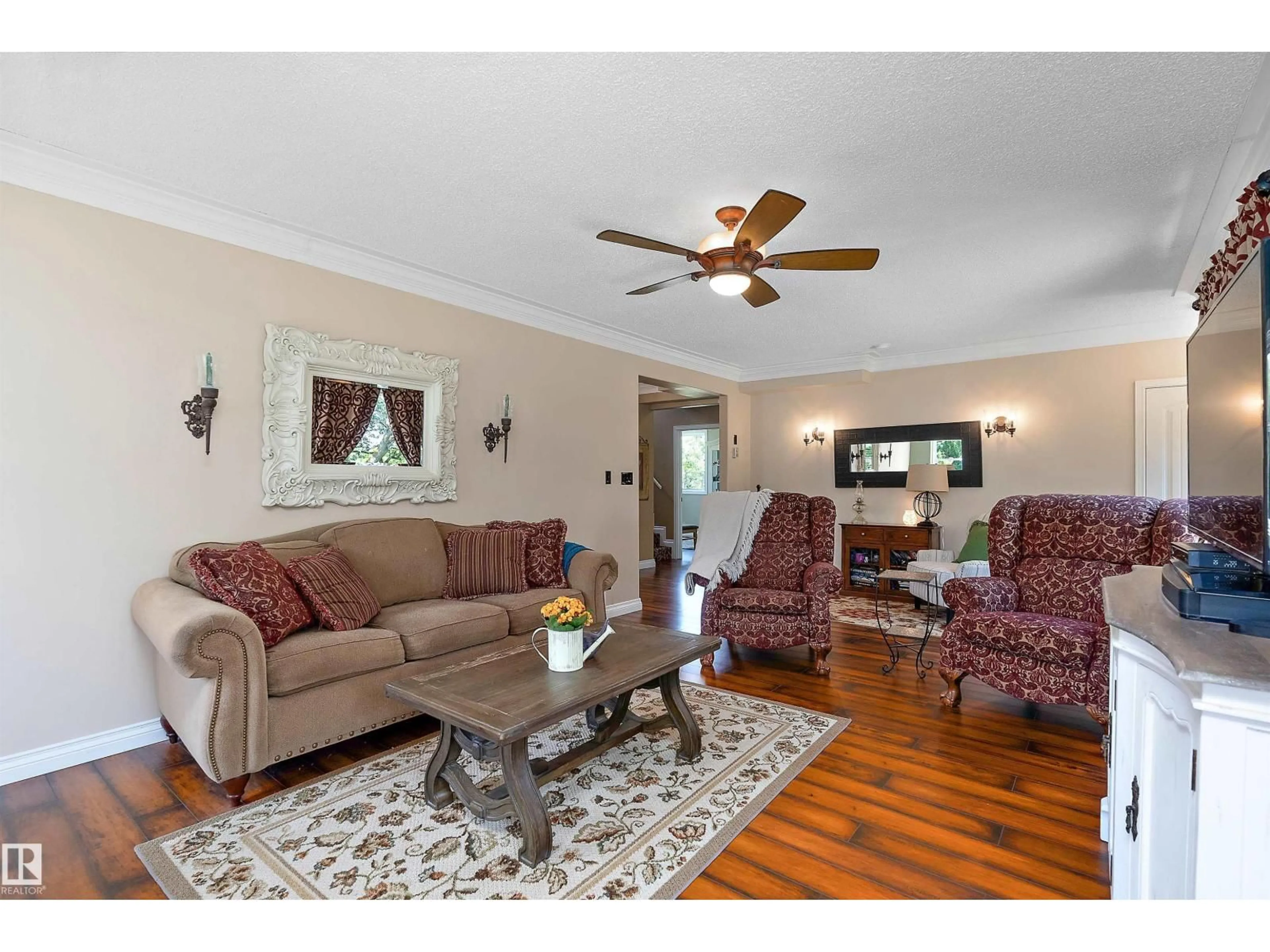 Living room with furniture, wood/laminate floor for 48114 RGE RD 262, Rural Leduc County Alberta T0C1Z0