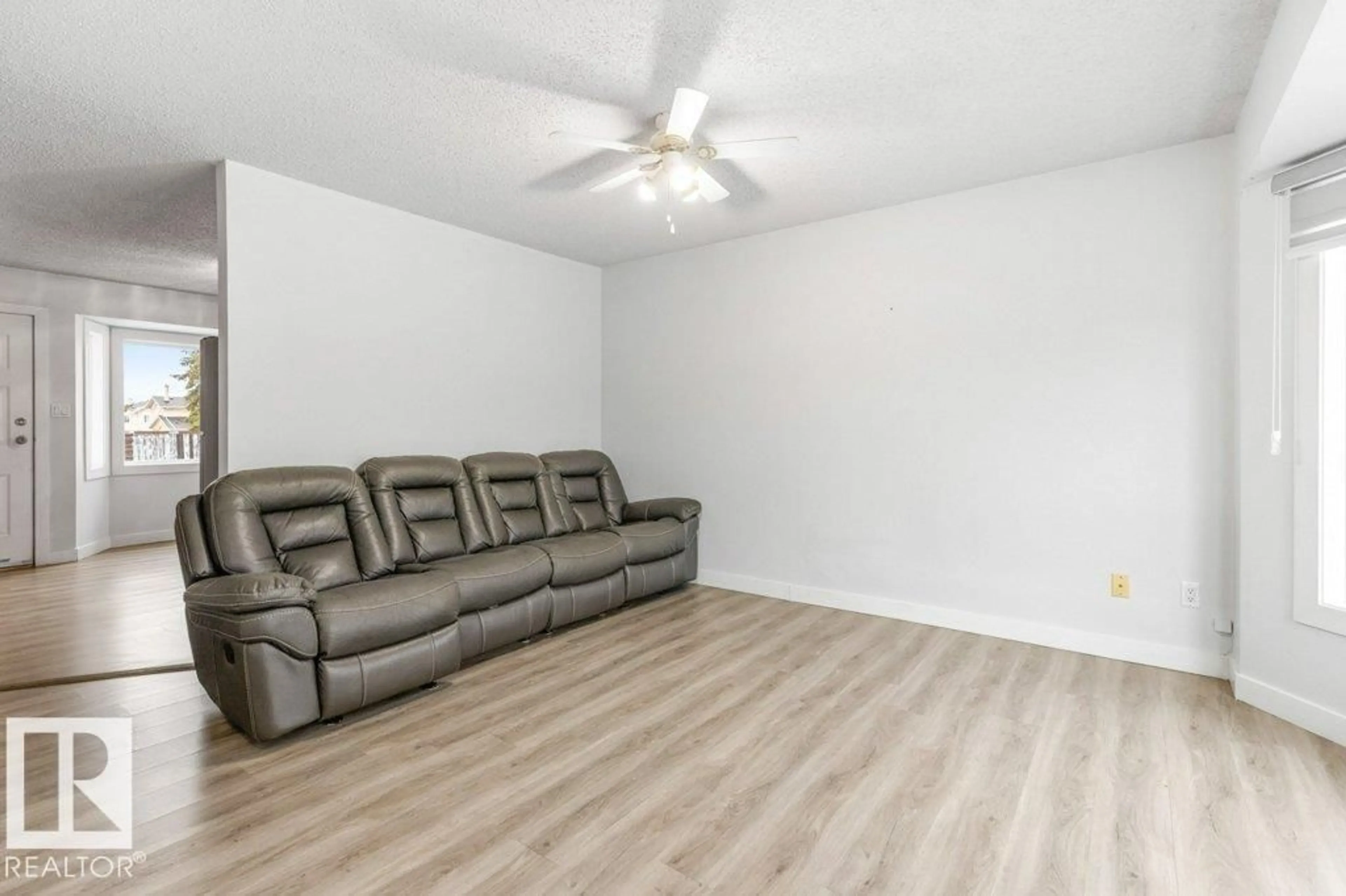 Living room with furniture, wood/laminate floor for 3132 49A ST, Edmonton Alberta T6L4Y6