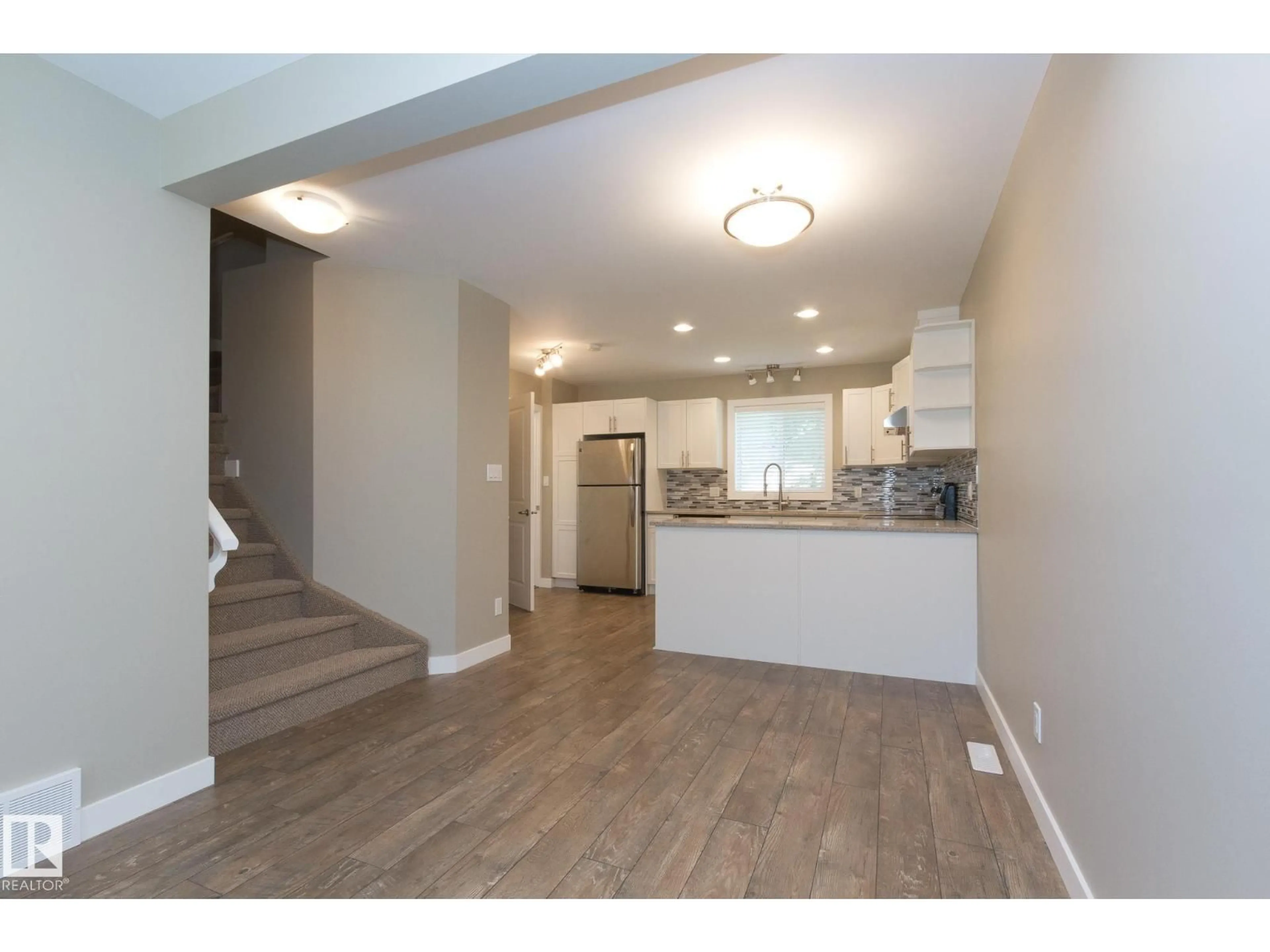 Open concept kitchen, wood/laminate floor for NW - 12504 119 AV, Edmonton Alberta T5L2Z5