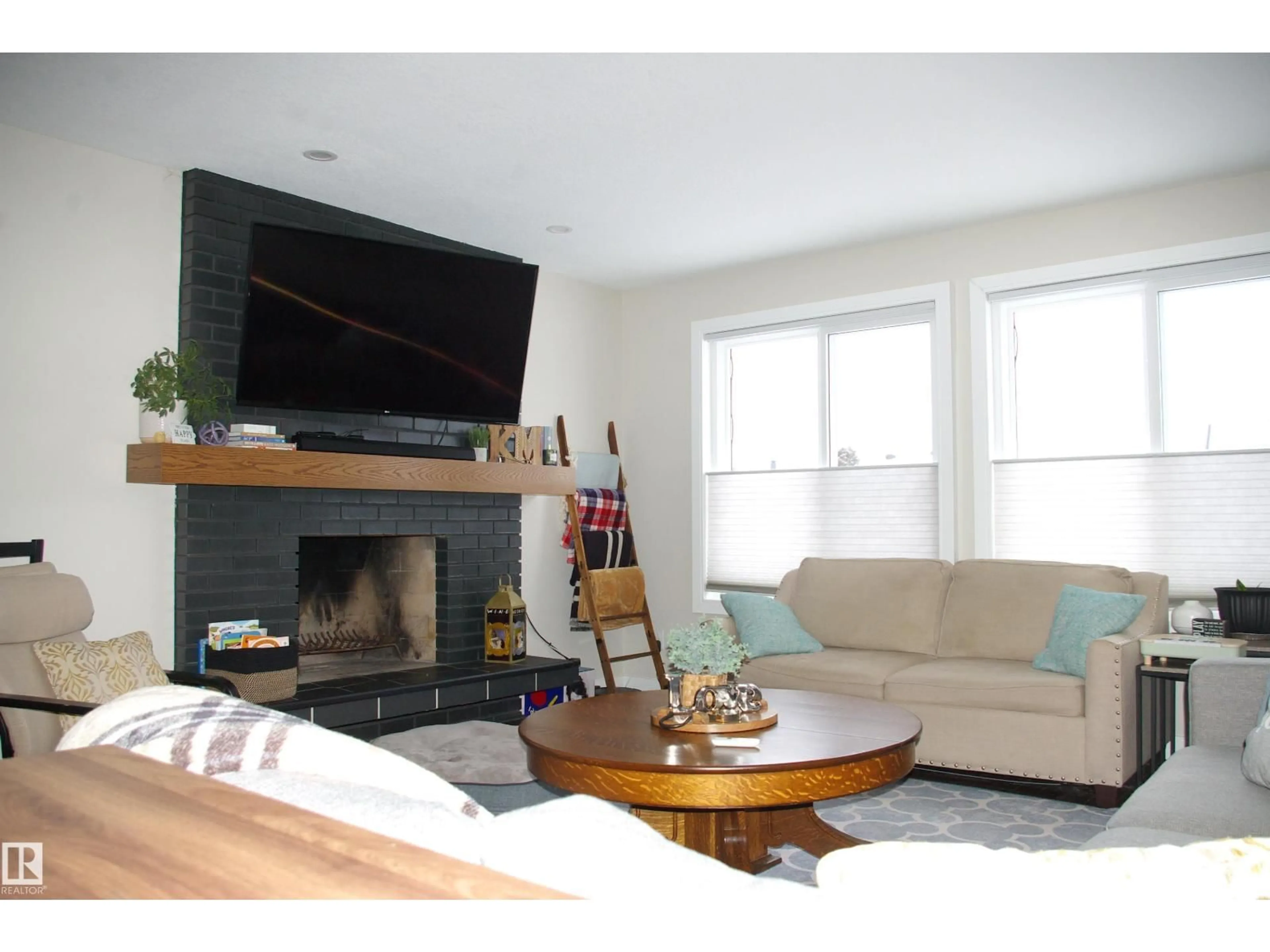 Living room with furniture, wood/laminate floor for 11907 152A AV, Edmonton Alberta T5X1E7
