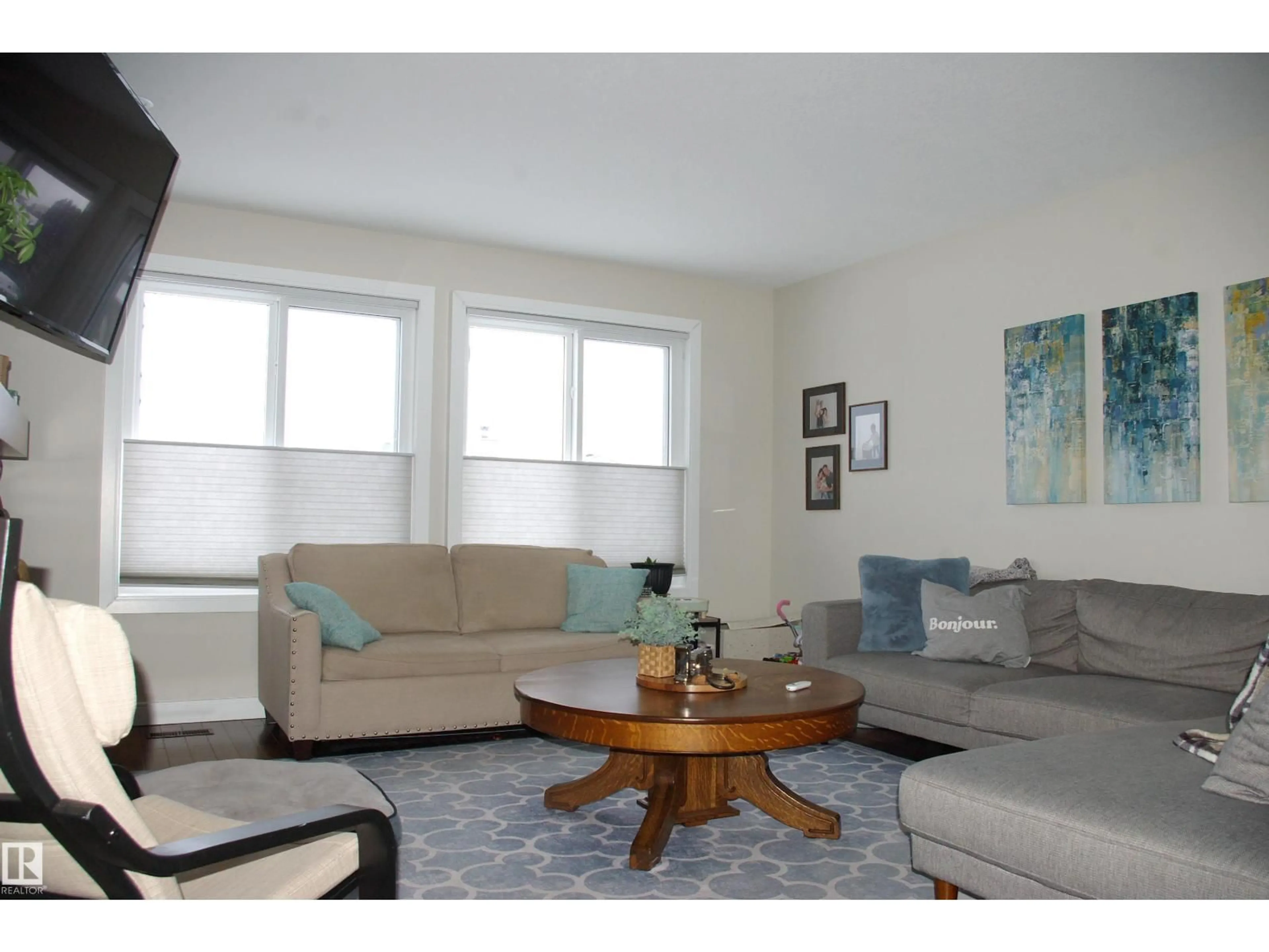 Living room with furniture, wood/laminate floor for 11907 152A AV, Edmonton Alberta T5X1E7