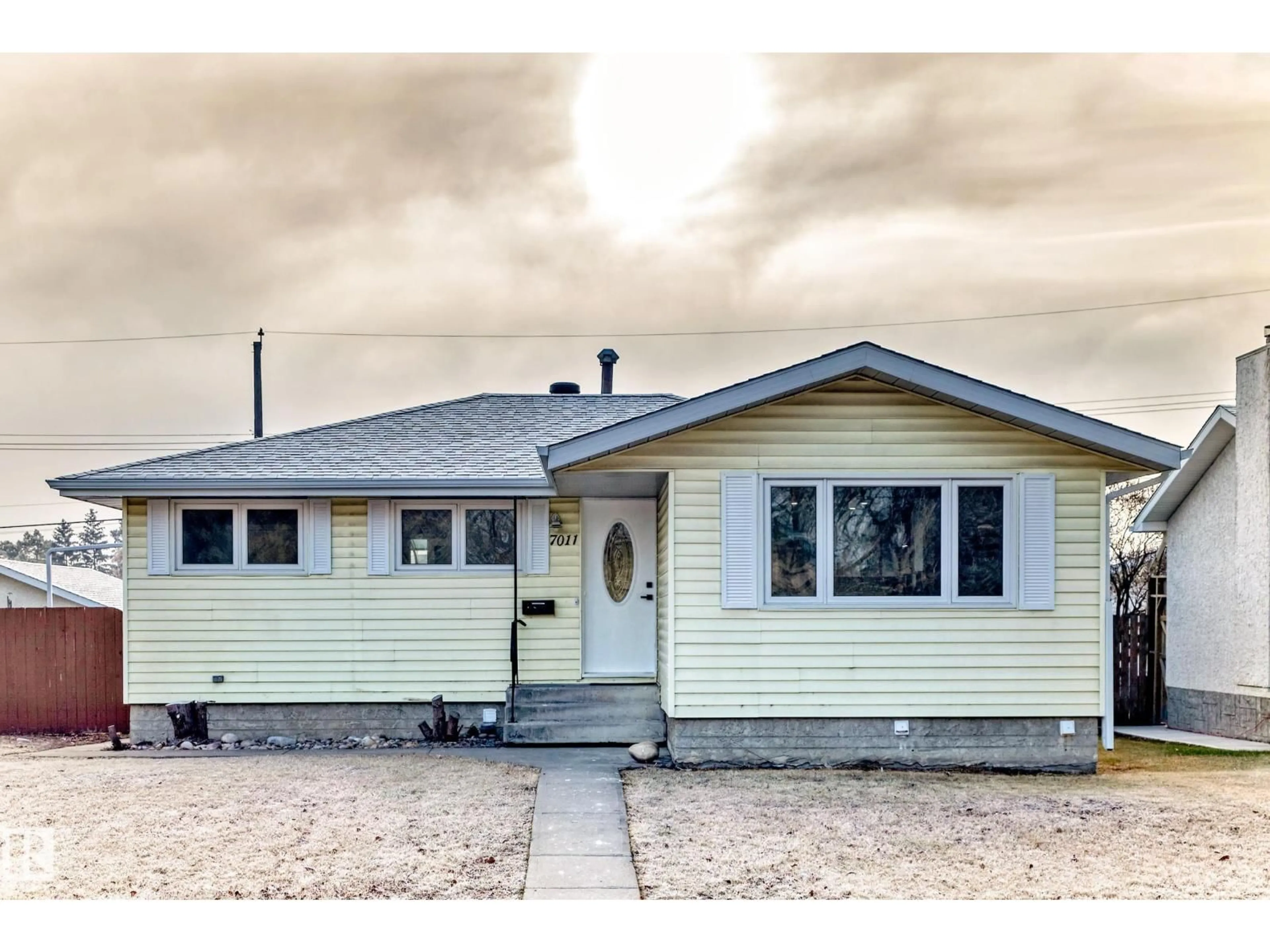 Home with vinyl exterior material, street for NW - 7011 135A AV, Edmonton Alberta T5C2H7