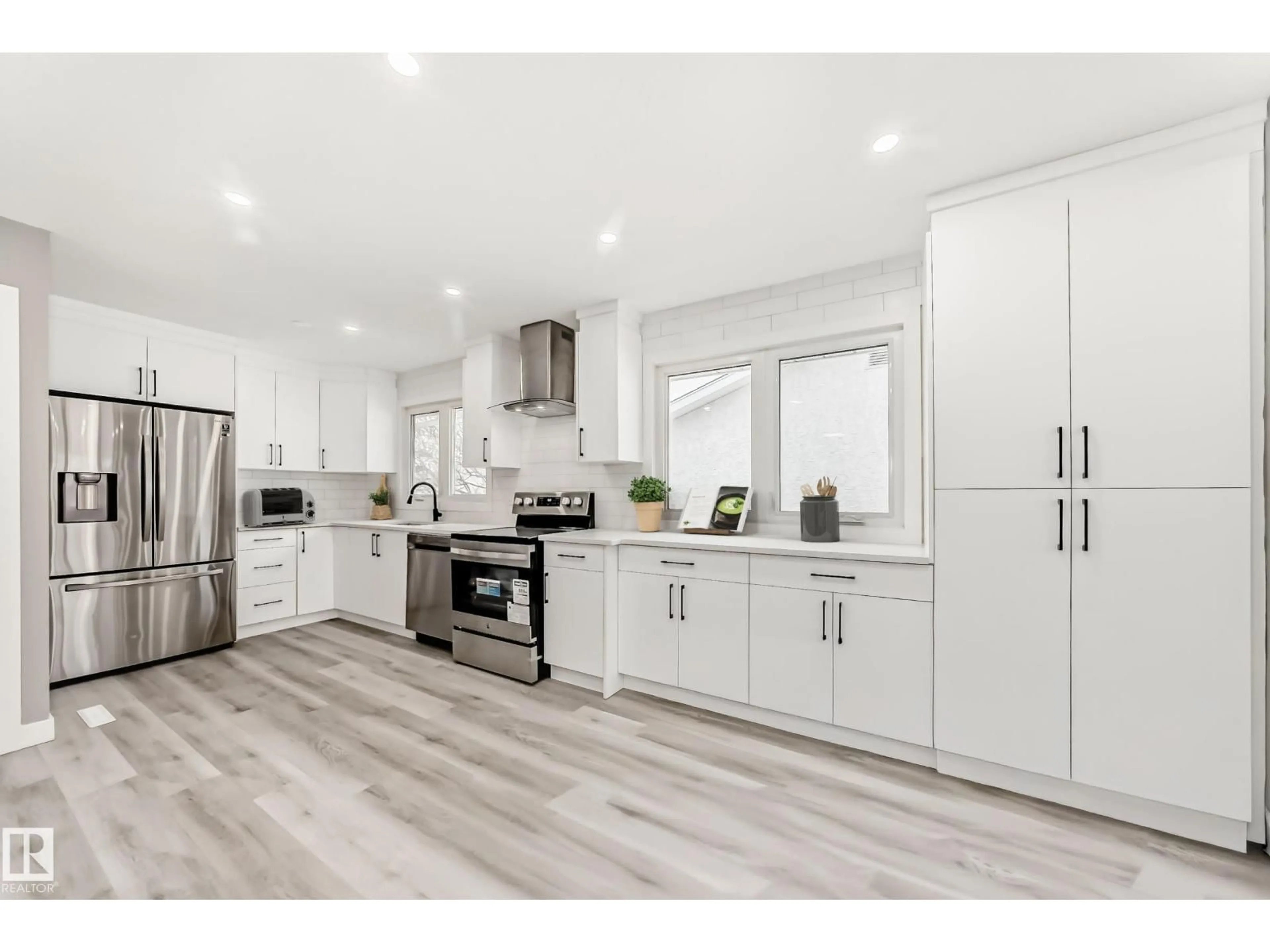 Open concept kitchen, wood/laminate floor for NW - 7011 135A AV, Edmonton Alberta T5C2H7