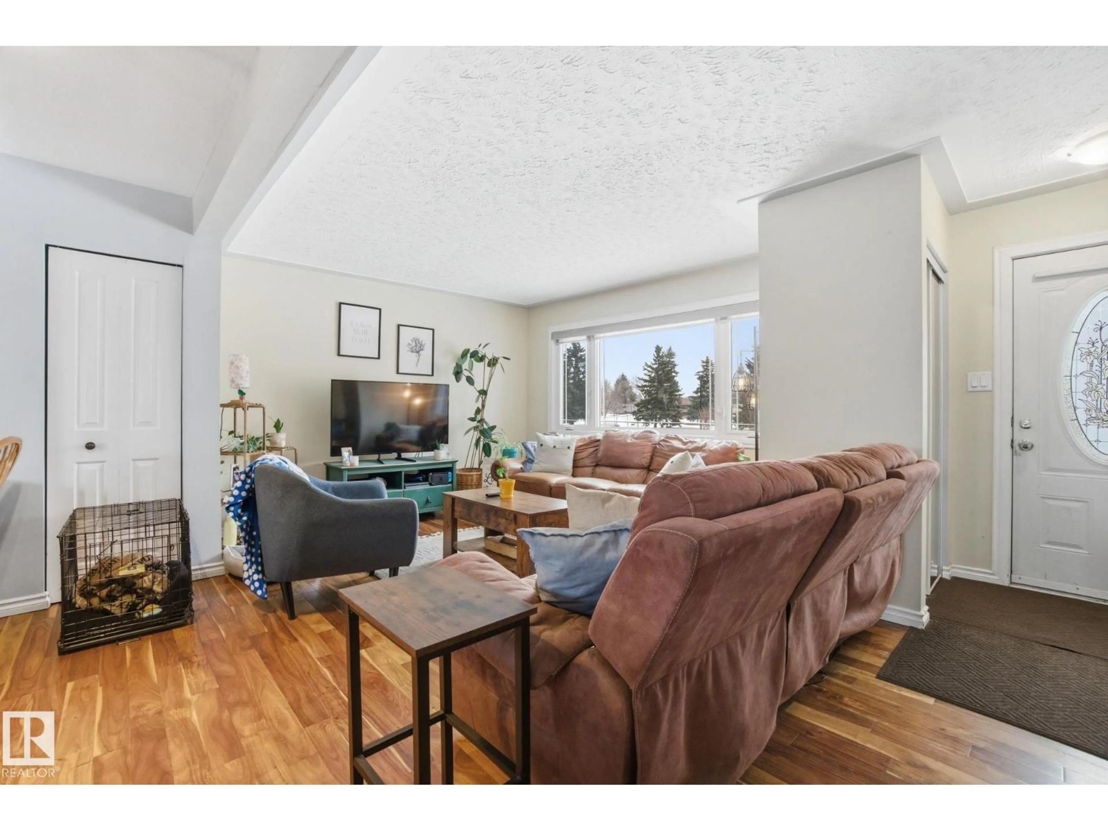 Living room with furniture, wood/laminate floor for NW - 12820 95 ST, Edmonton Alberta T5E3Y1