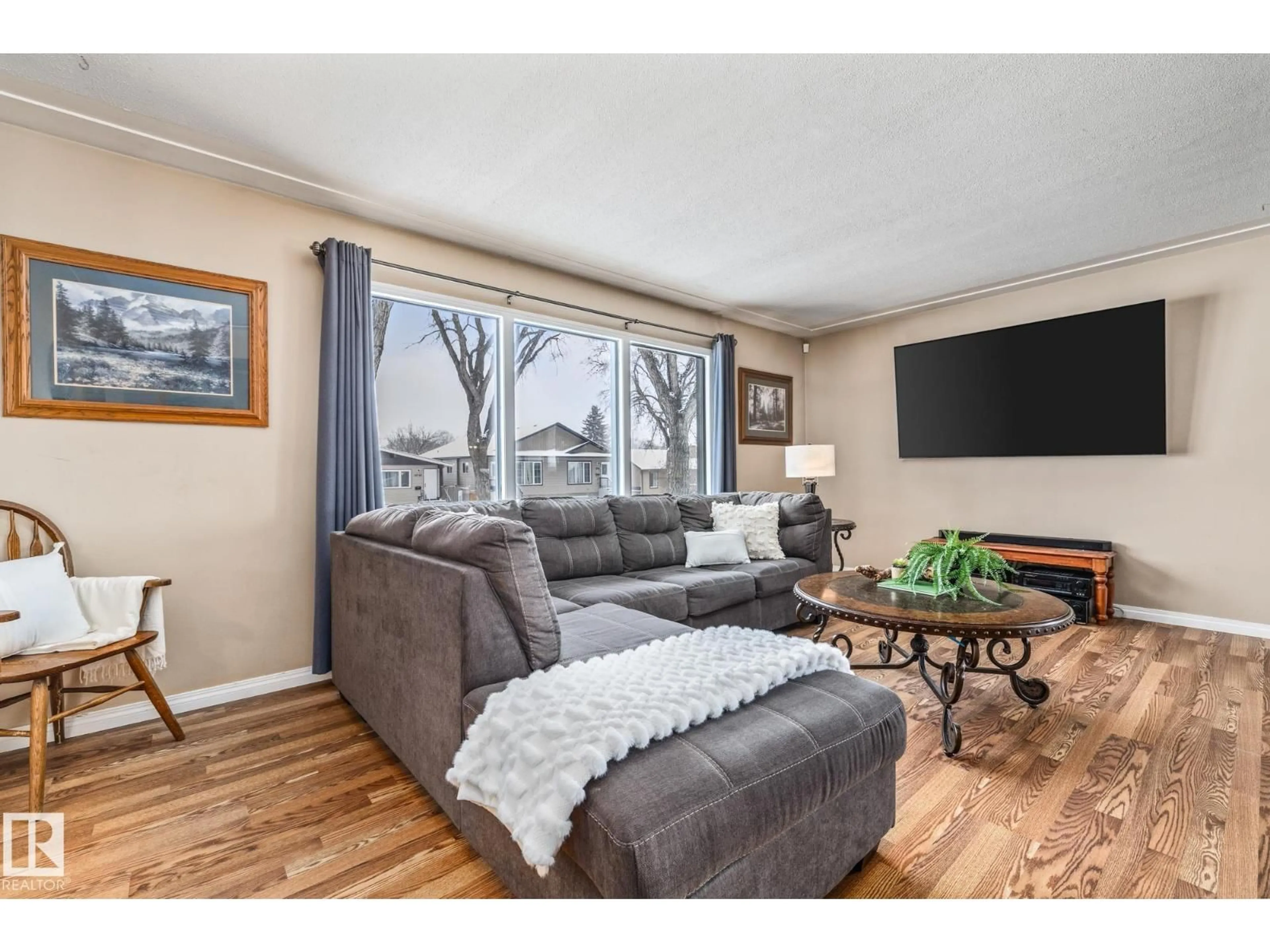 Living room with furniture, wood/laminate floor for 12752 116 ST, Edmonton Alberta T5E5H2