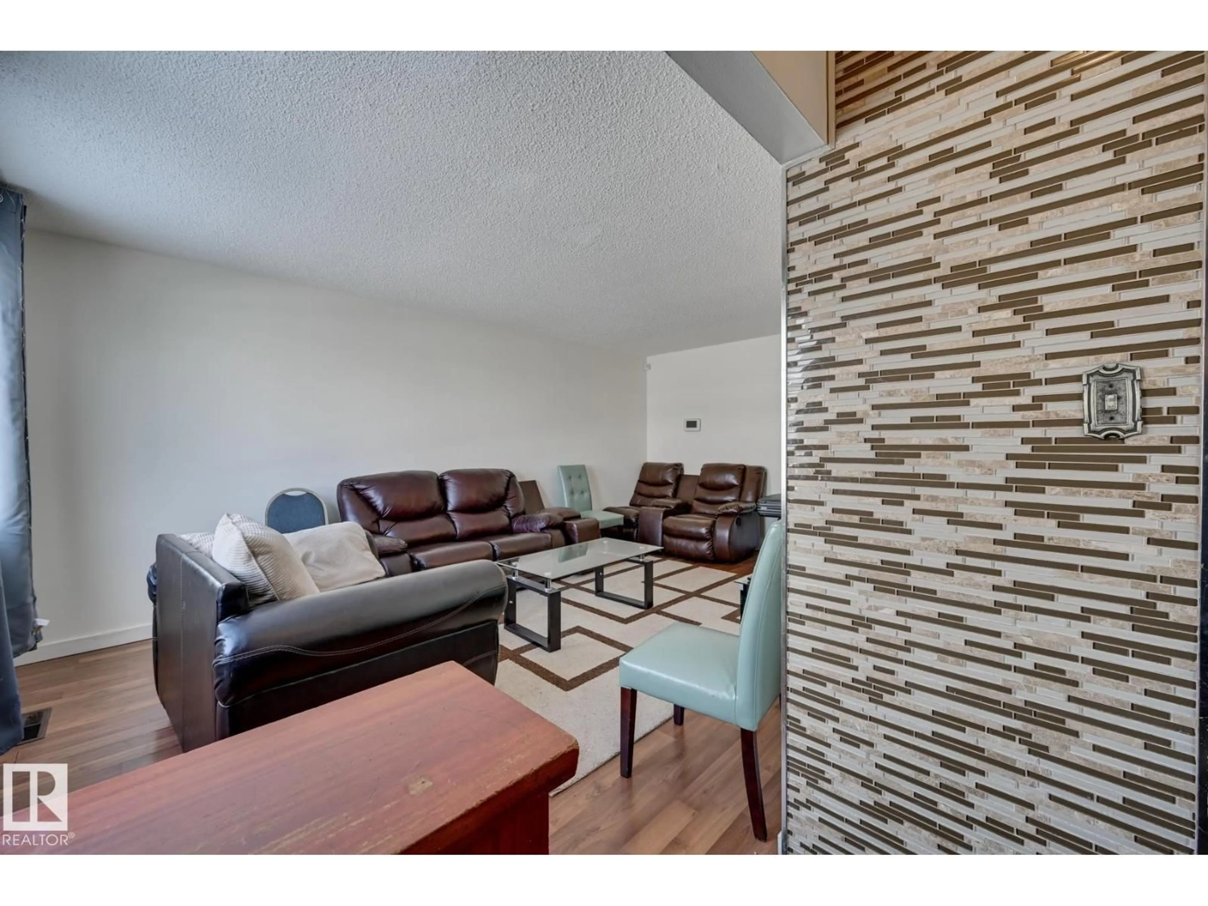 Living room with furniture, wood/laminate floor for 6621 132 AV, Edmonton Alberta T5C2A4
