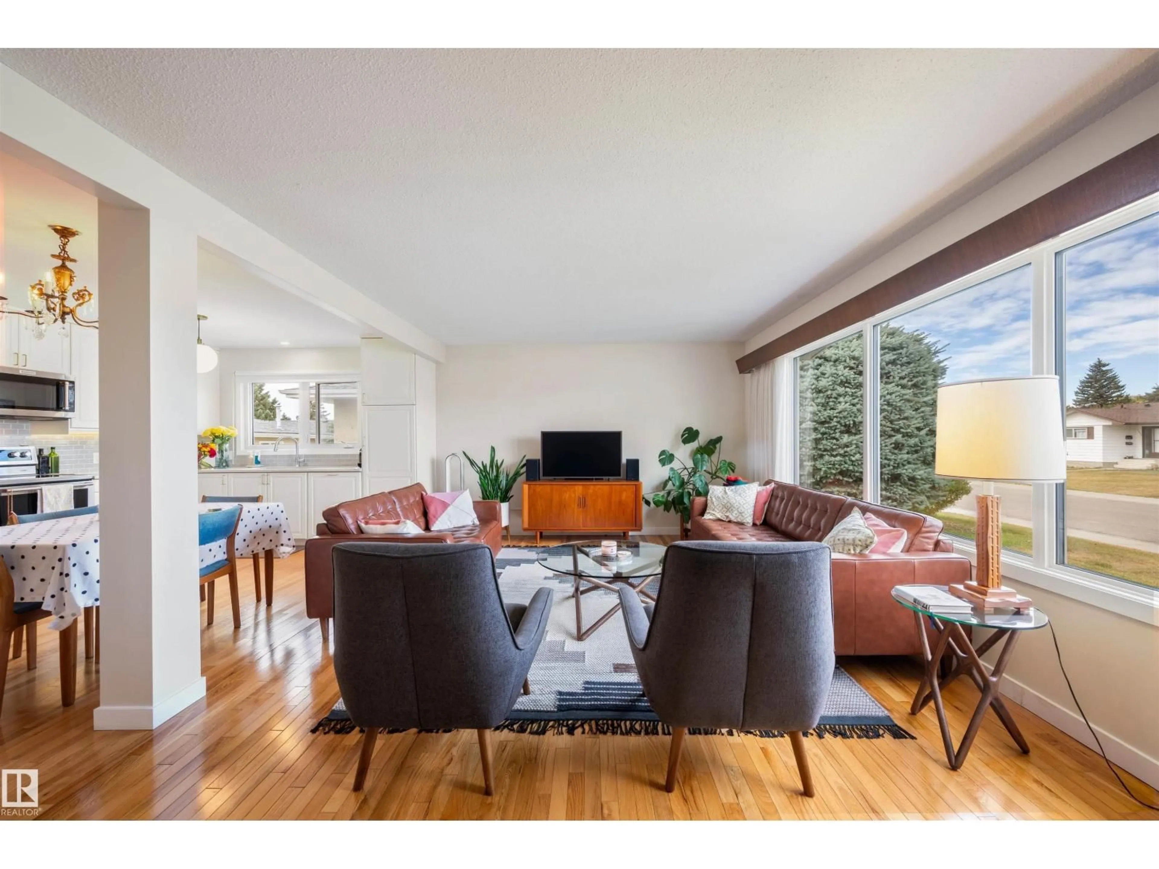 Living room with furniture, wood/laminate floor for 7811 148 AV, Edmonton Alberta T5C2T8