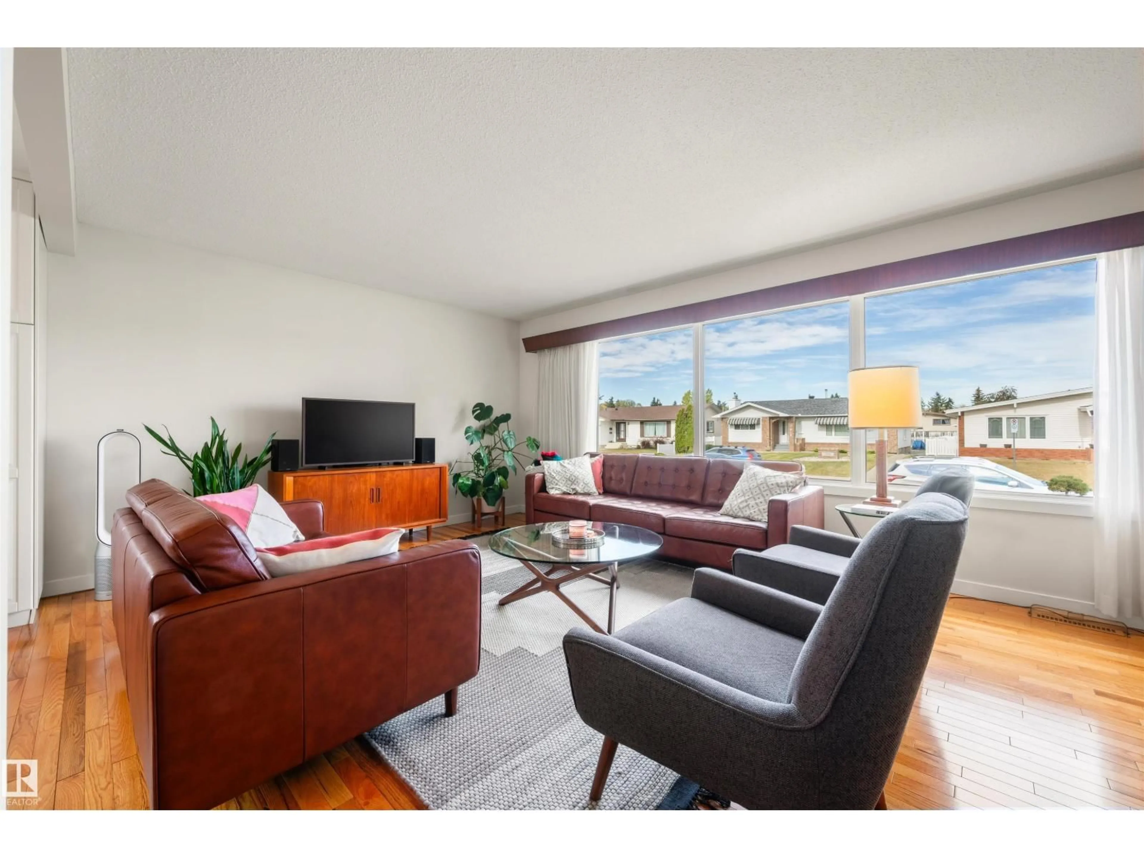 Living room with furniture, wood/laminate floor for 7811 148 AV, Edmonton Alberta T5C2T8