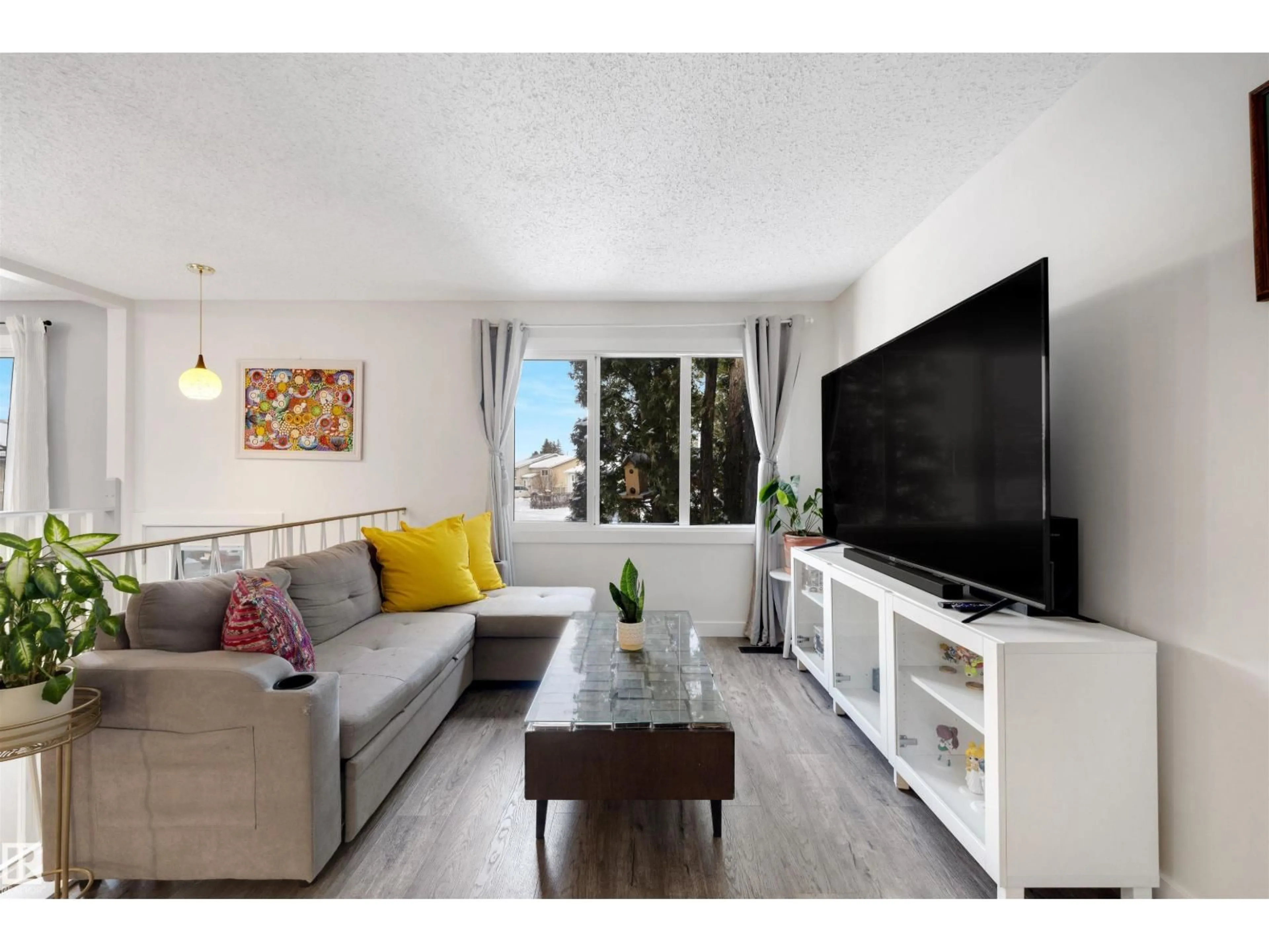 Living room with furniture, wood/laminate floor for 107 WARWICK RD, Edmonton Alberta T5Z4P7