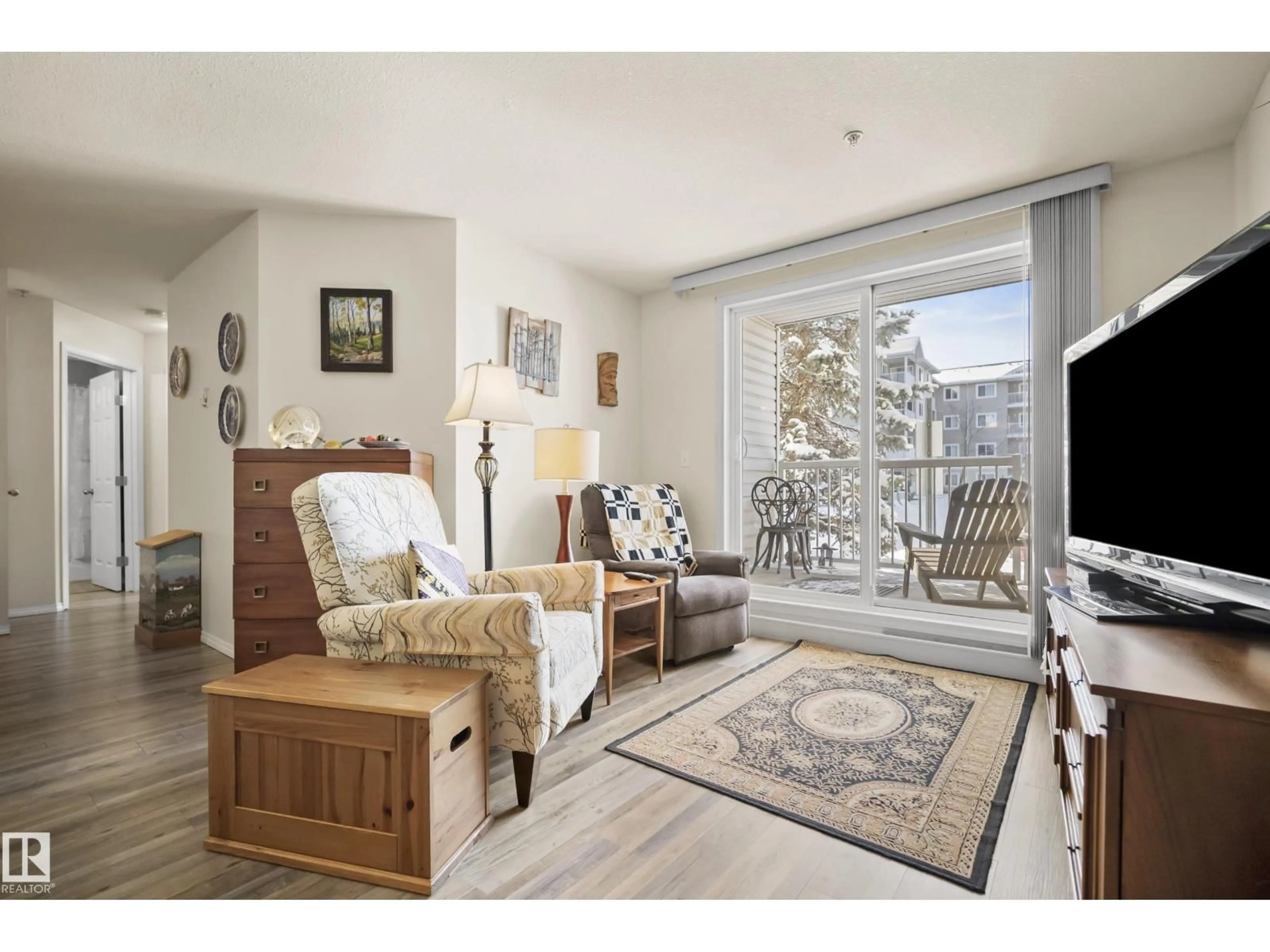 Living room with furniture, wood/laminate floor for 128 - 4309 33 33 ST, Stony Plain Alberta T7Z0C4