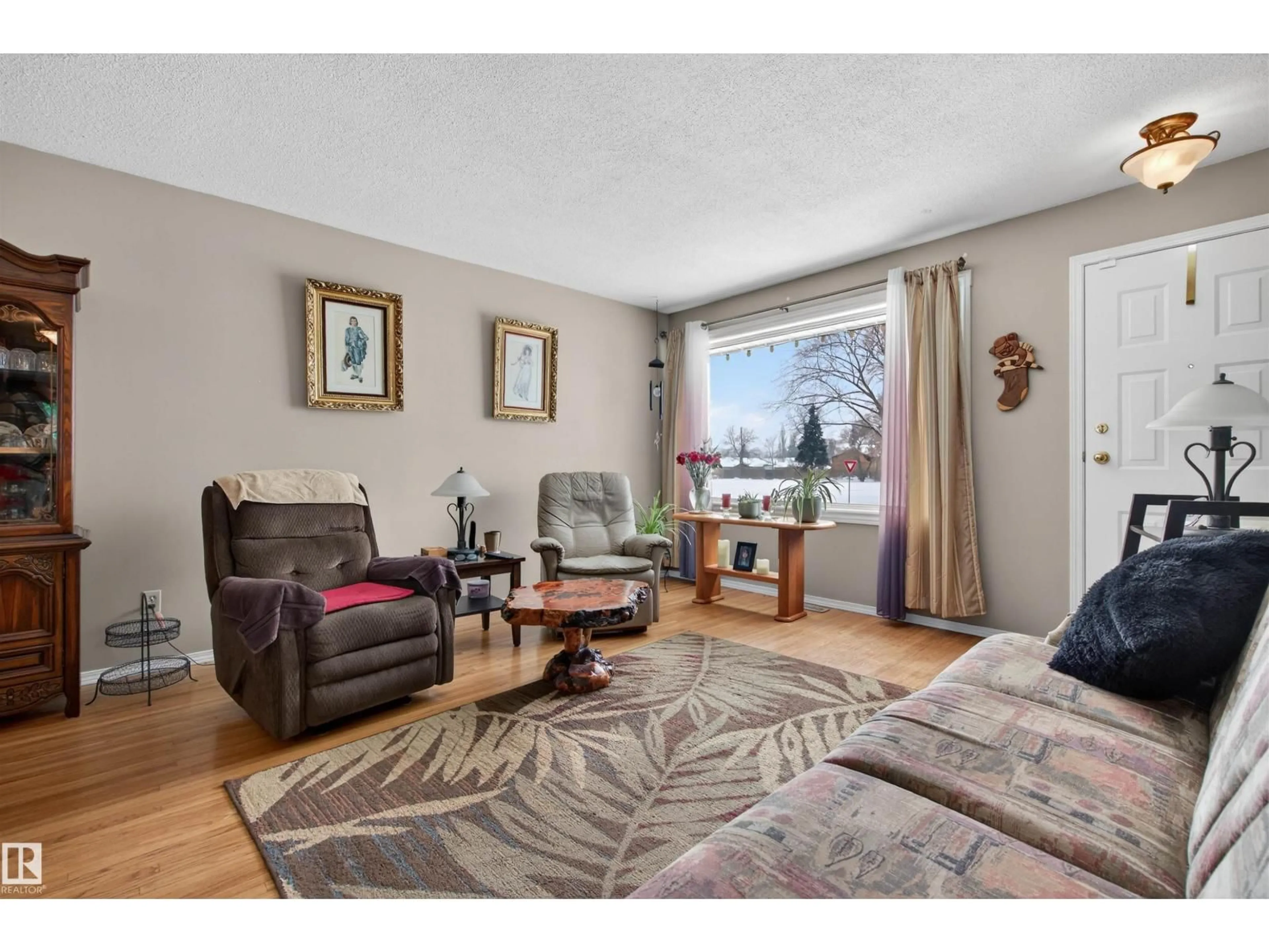Living room with furniture, wood/laminate floor for 16031 105 AV, Edmonton Alberta T5P0T8
