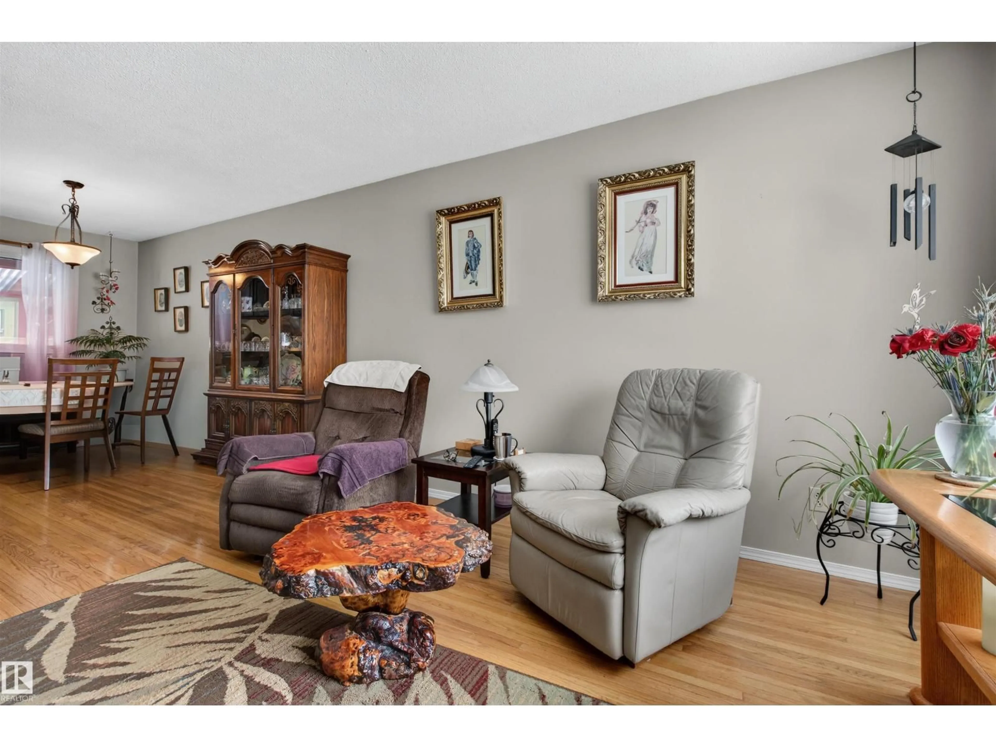 Living room with furniture, wood/laminate floor for 16031 105 AV, Edmonton Alberta T5P0T8