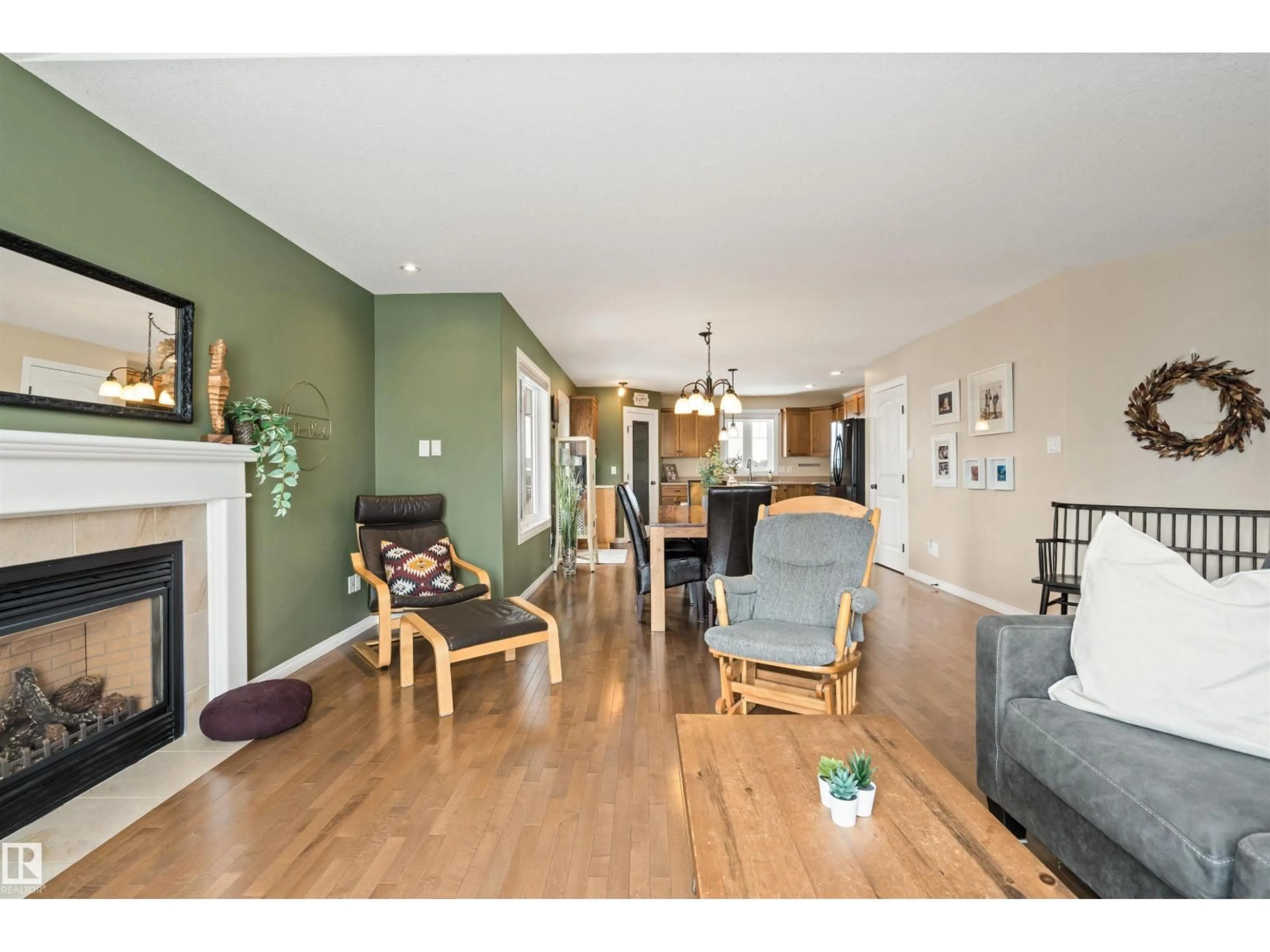 Living room with furniture, wood/laminate floor for 116 LOGPERCH CR, Cold Lake Alberta T9M0B3