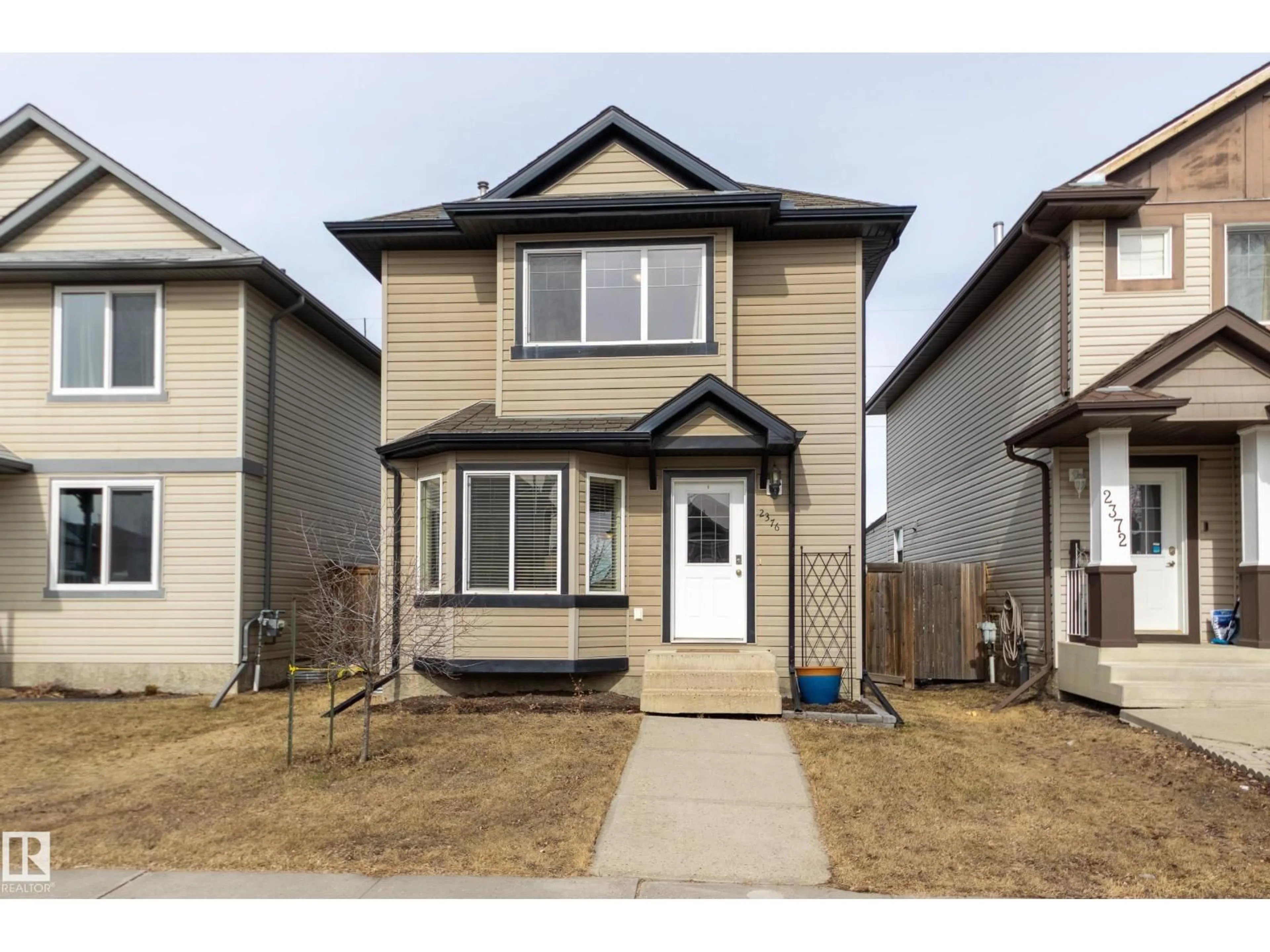 Home with vinyl exterior material, street for 2376 30 AV, Edmonton Alberta T6T1Z8