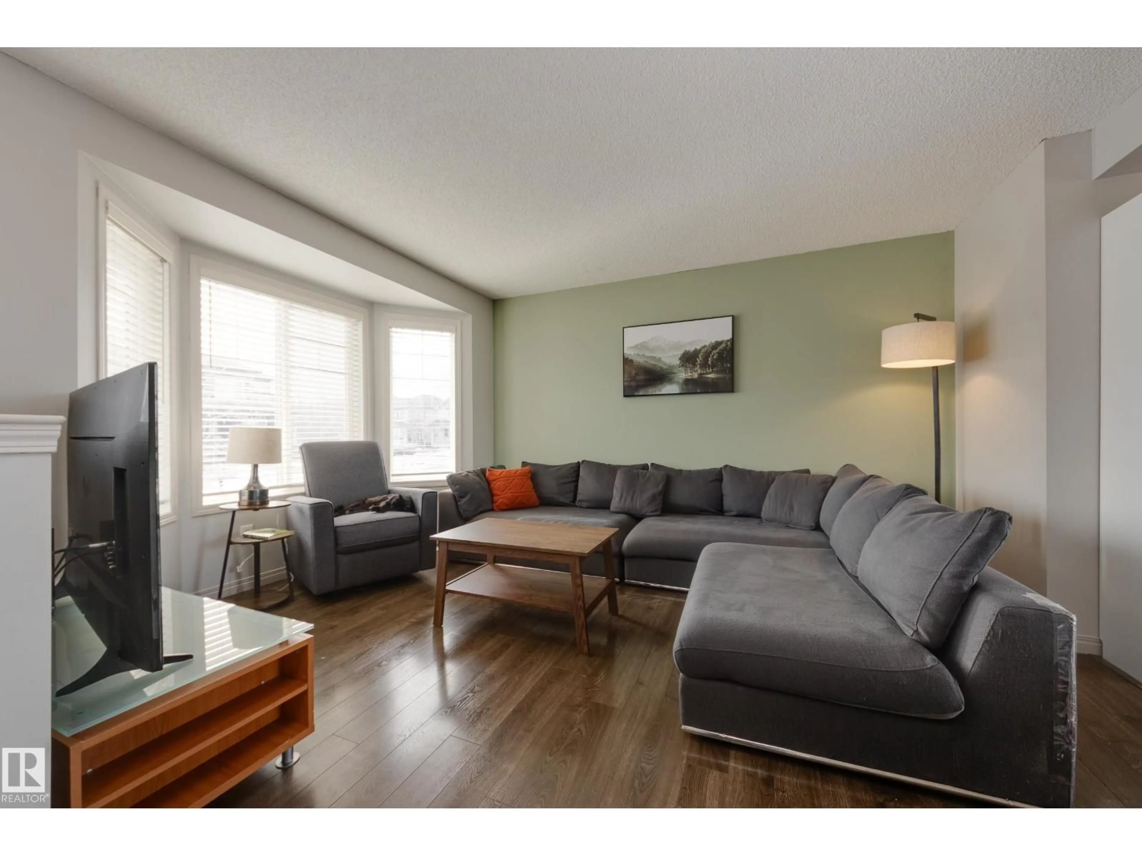 Living room with furniture, wood/laminate floor for 2376 30 AV, Edmonton Alberta T6T1Z8