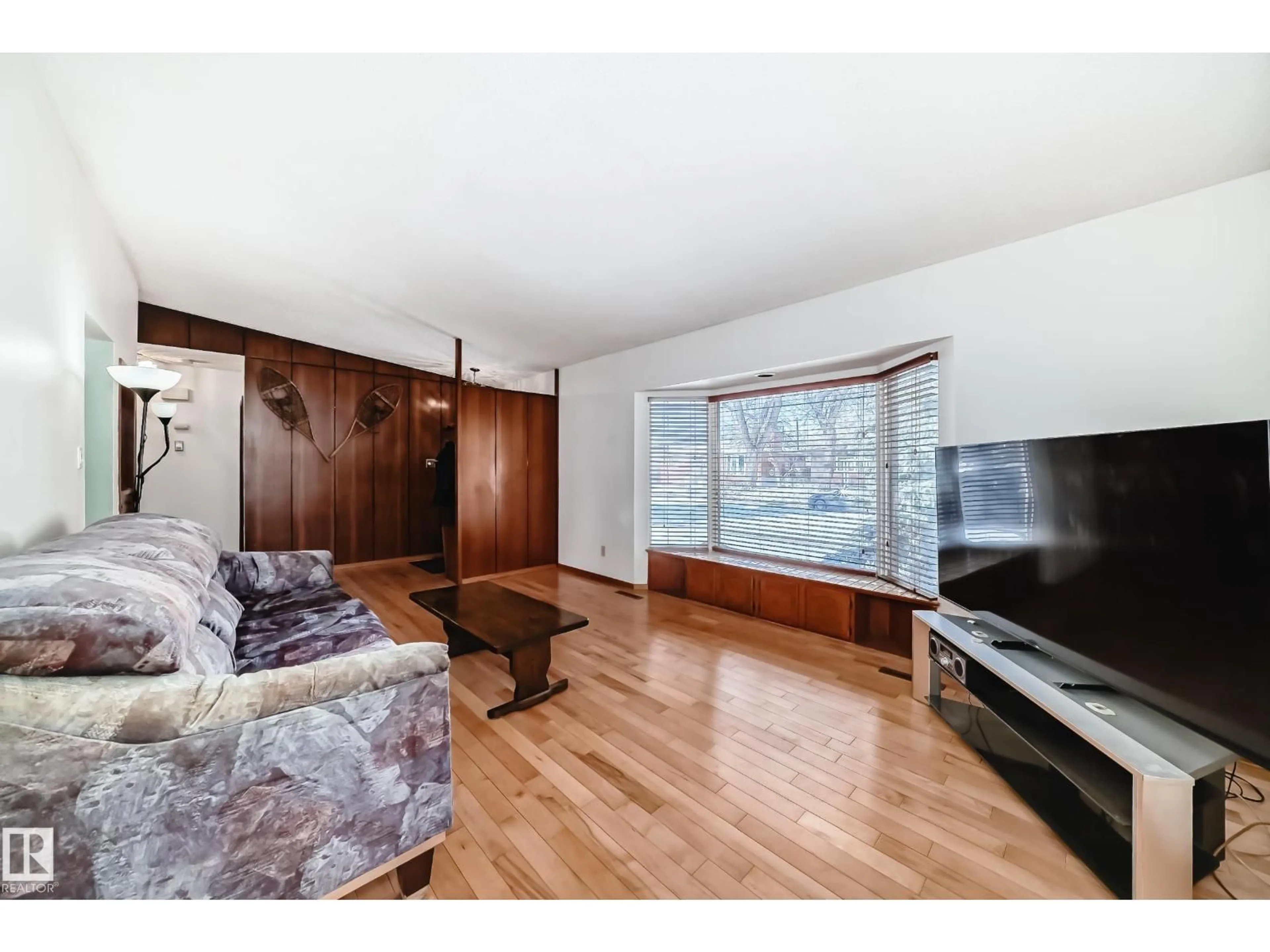 Living room with furniture, wood/laminate floor for 4237 116 AV, Edmonton Alberta T5W0W9