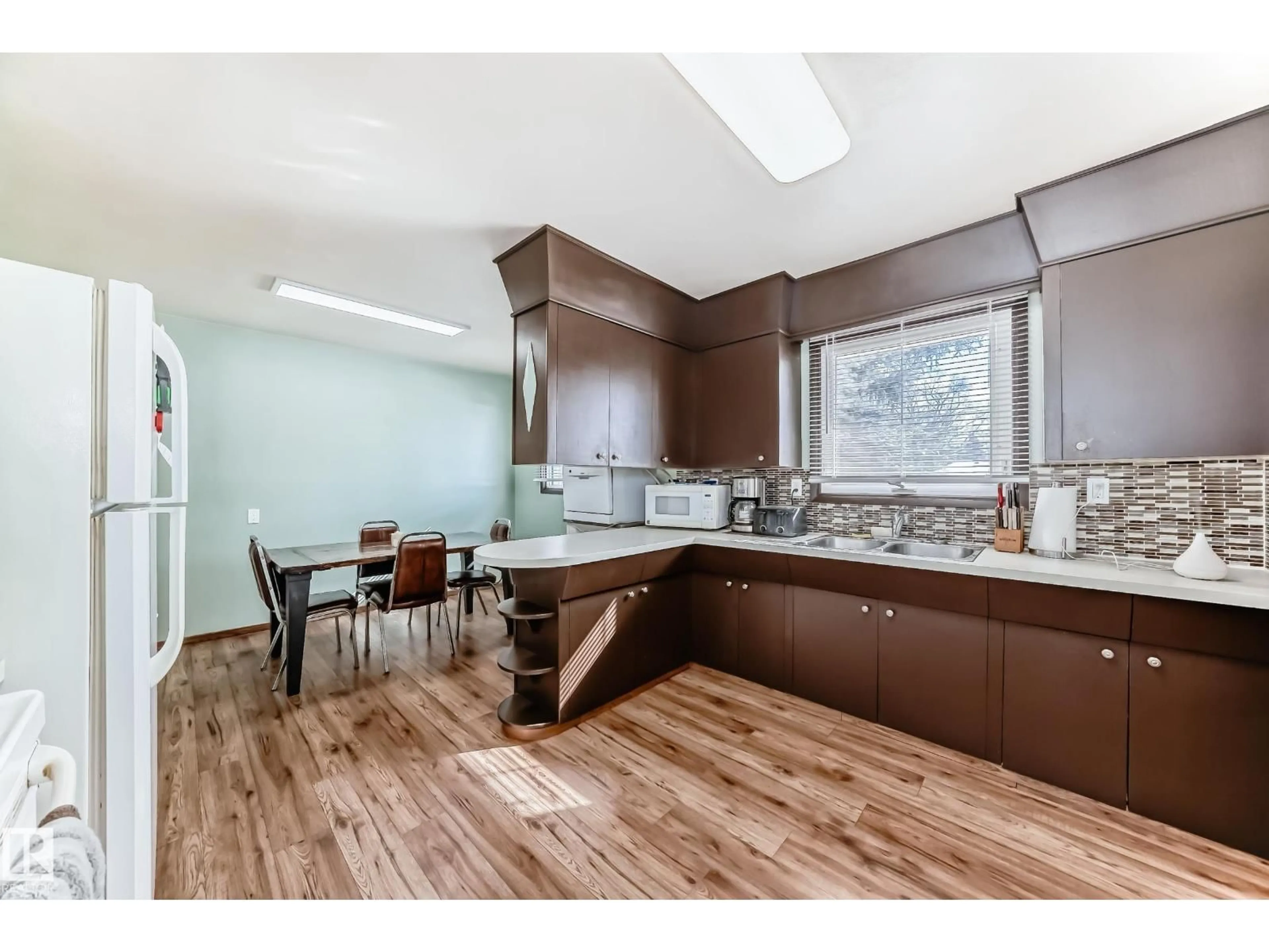 Open concept kitchen, wood/laminate floor for 4237 116 AV, Edmonton Alberta T5W0W9