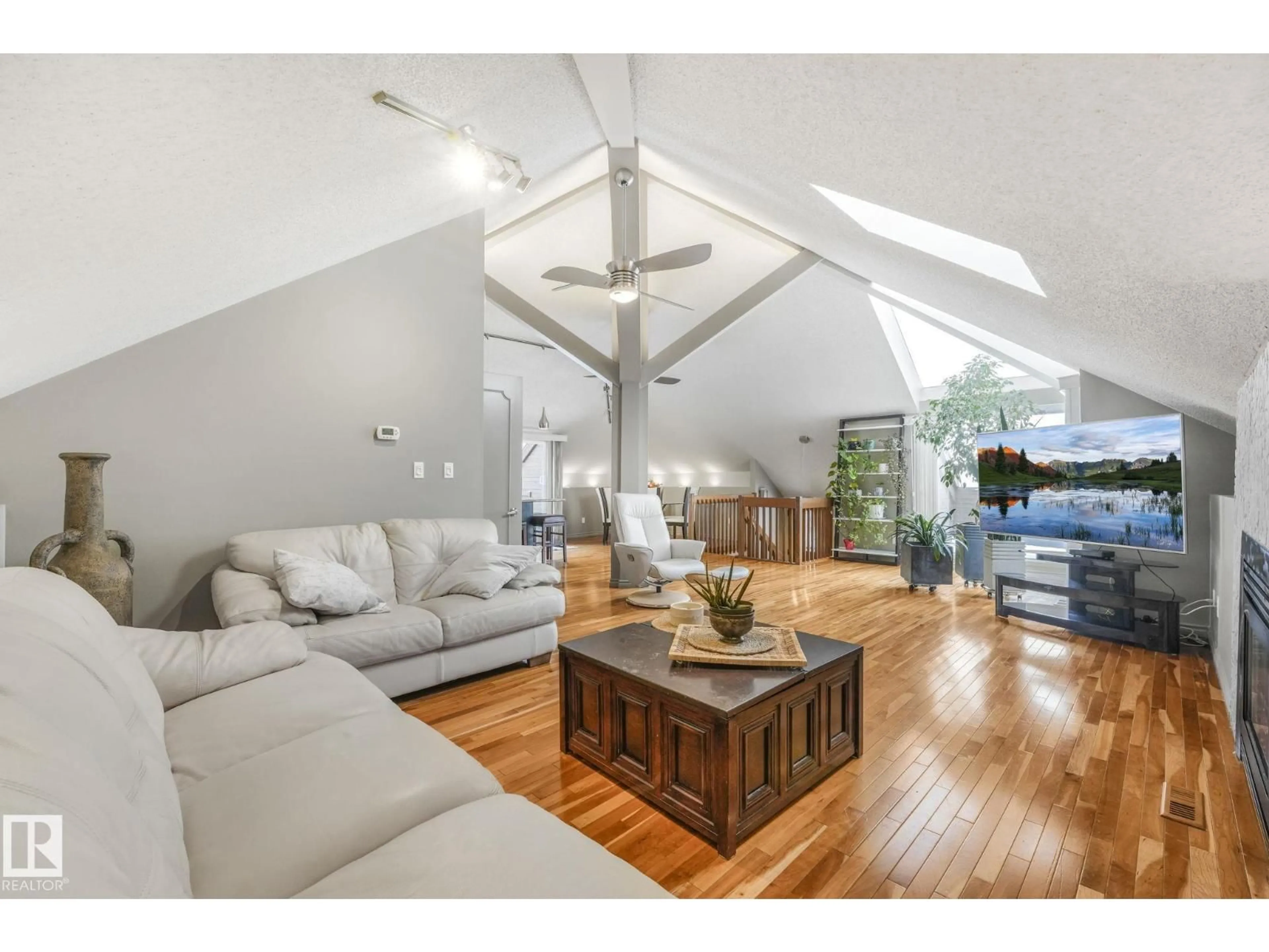 Living room with furniture, wood/laminate floor for NW - 5807 185 ST, Edmonton Alberta T6M1Y1