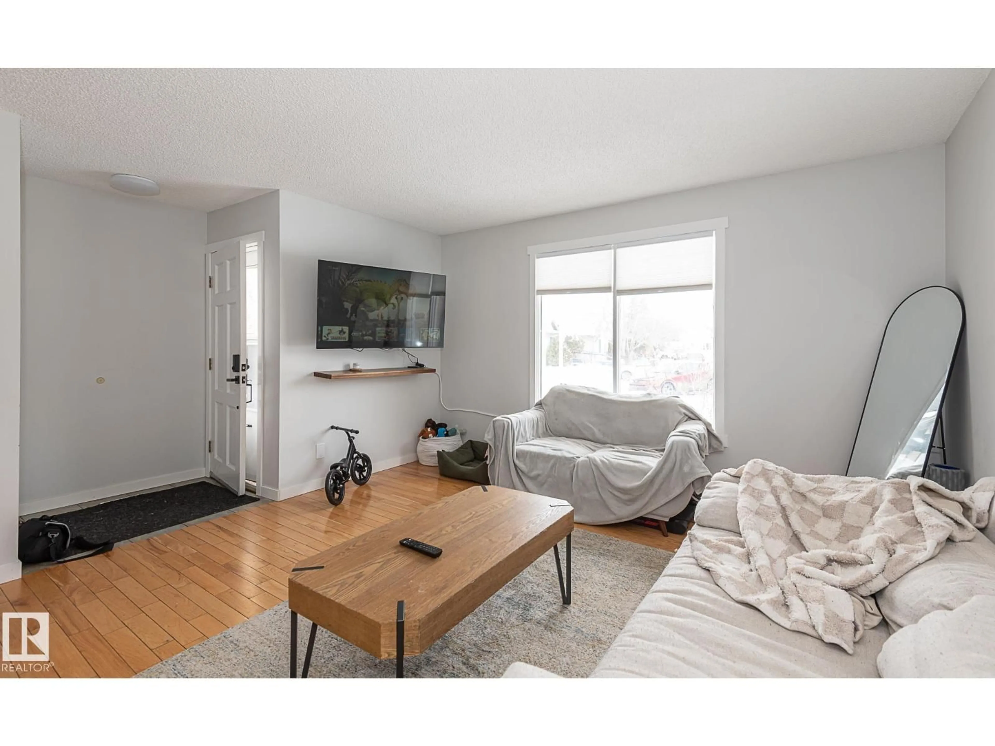 Living room with furniture, wood/laminate floor for 8326 157 AV, Edmonton Alberta T5Z2P7