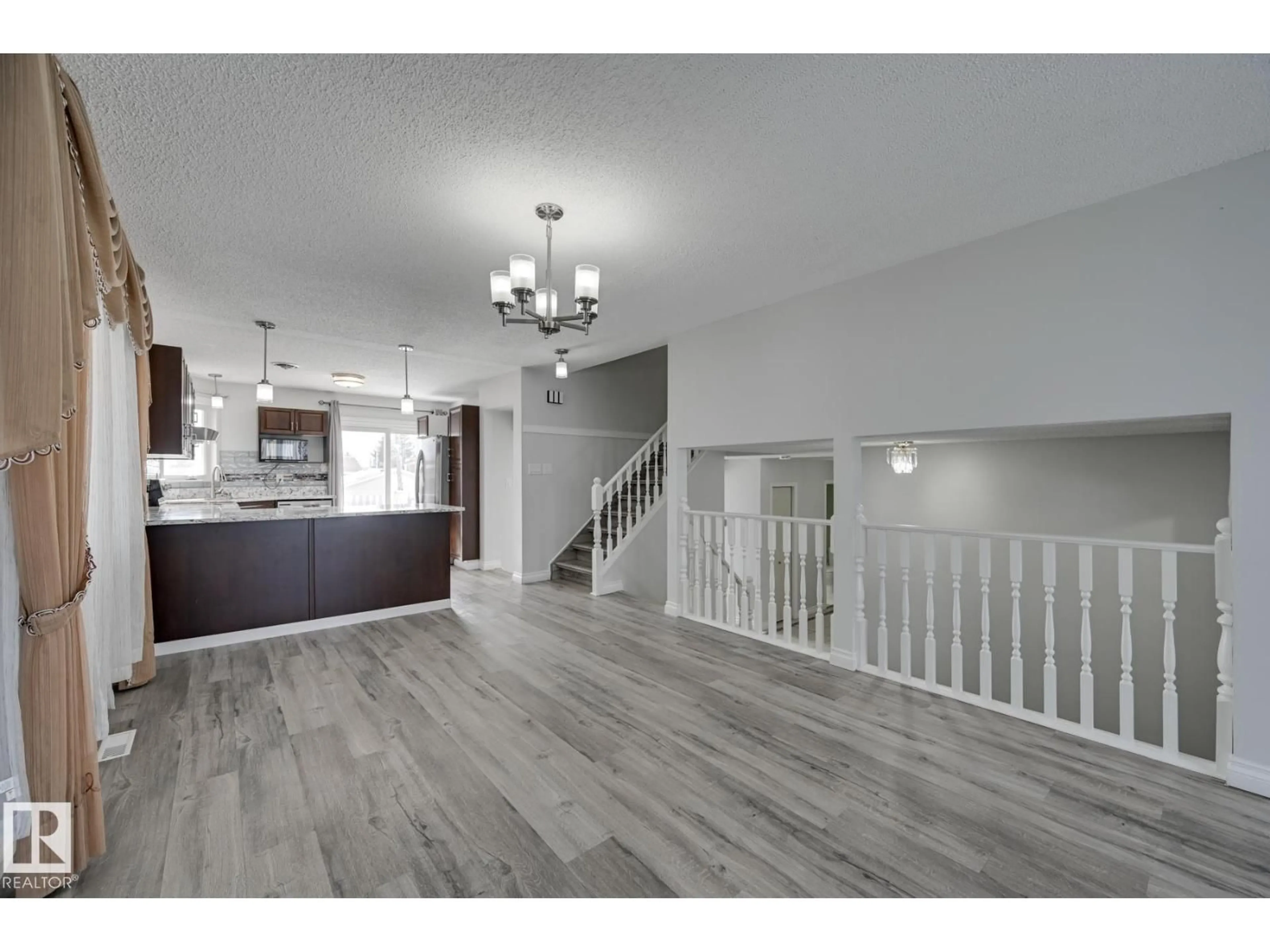 Open concept kitchen, wood/laminate floor for NW - 8507 152B AV, Edmonton Alberta T5E5V7