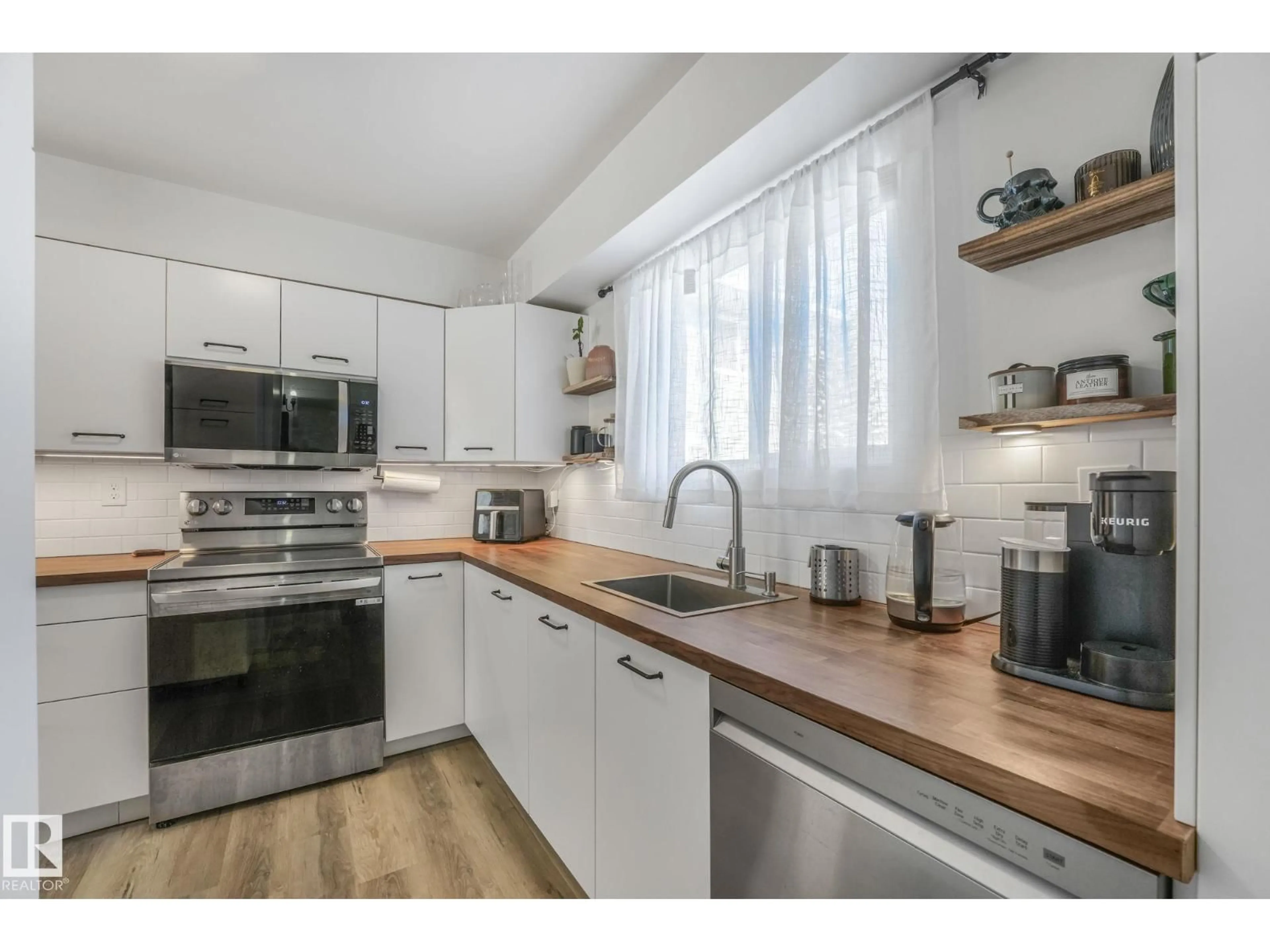Open concept kitchen, wood/laminate floor for #33 - 4403 RIVERBEND RD, Edmonton Alberta T6H5S9