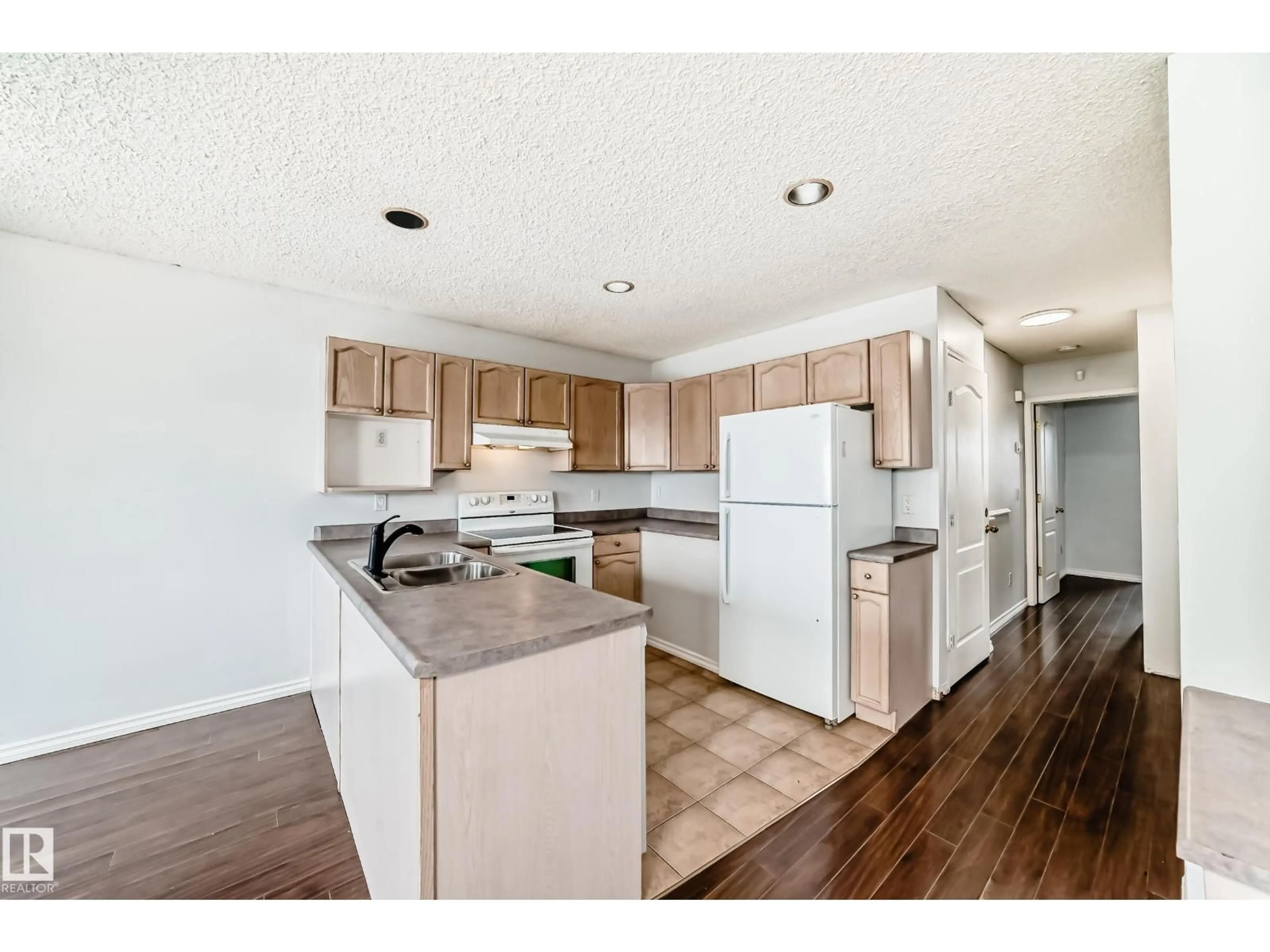 Open concept kitchen, wood/laminate floor for 1911 36 AV, Edmonton Alberta T6T1S9