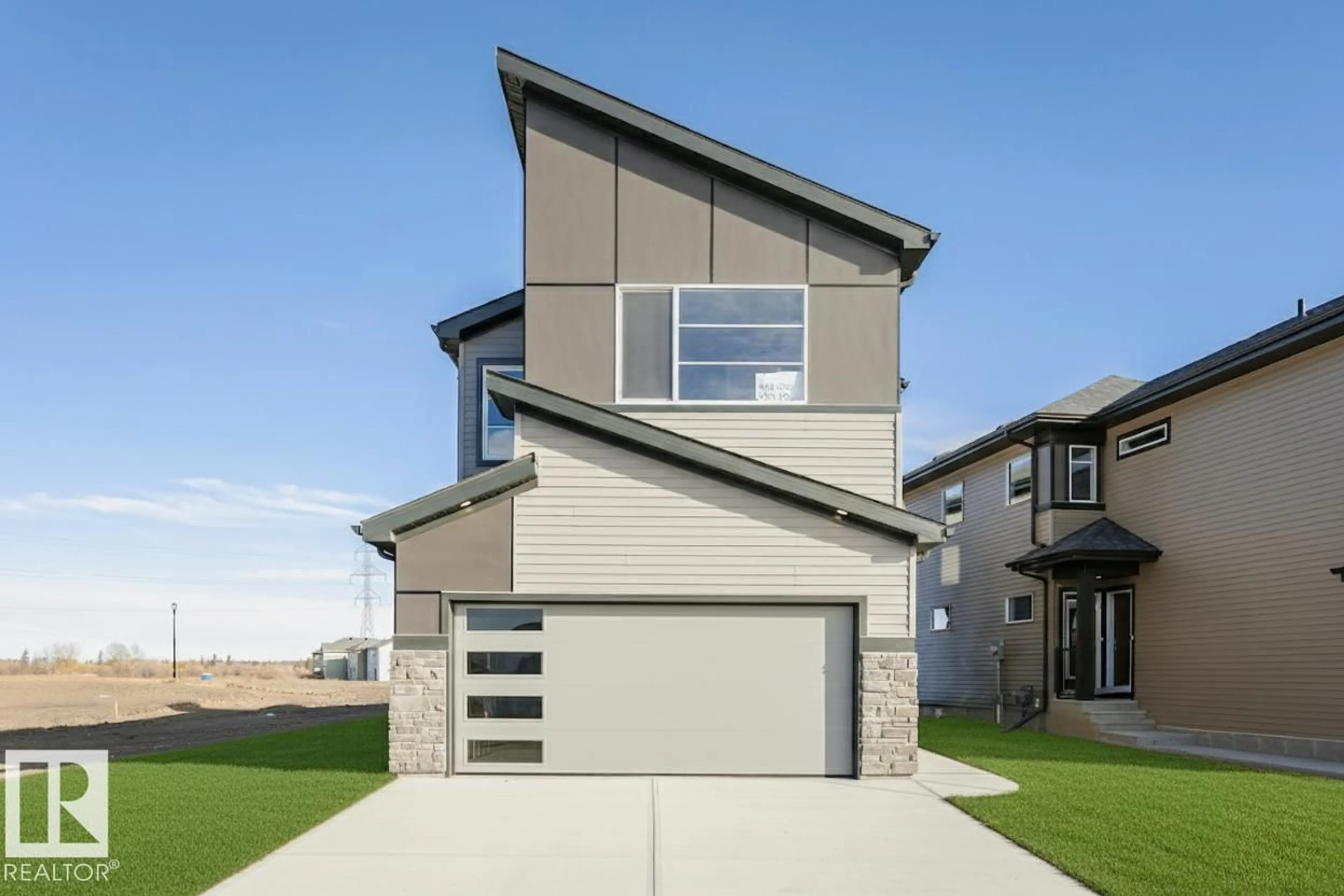 Home with vinyl exterior material, street for 332 173 AV, Edmonton Alberta T5Y4G6