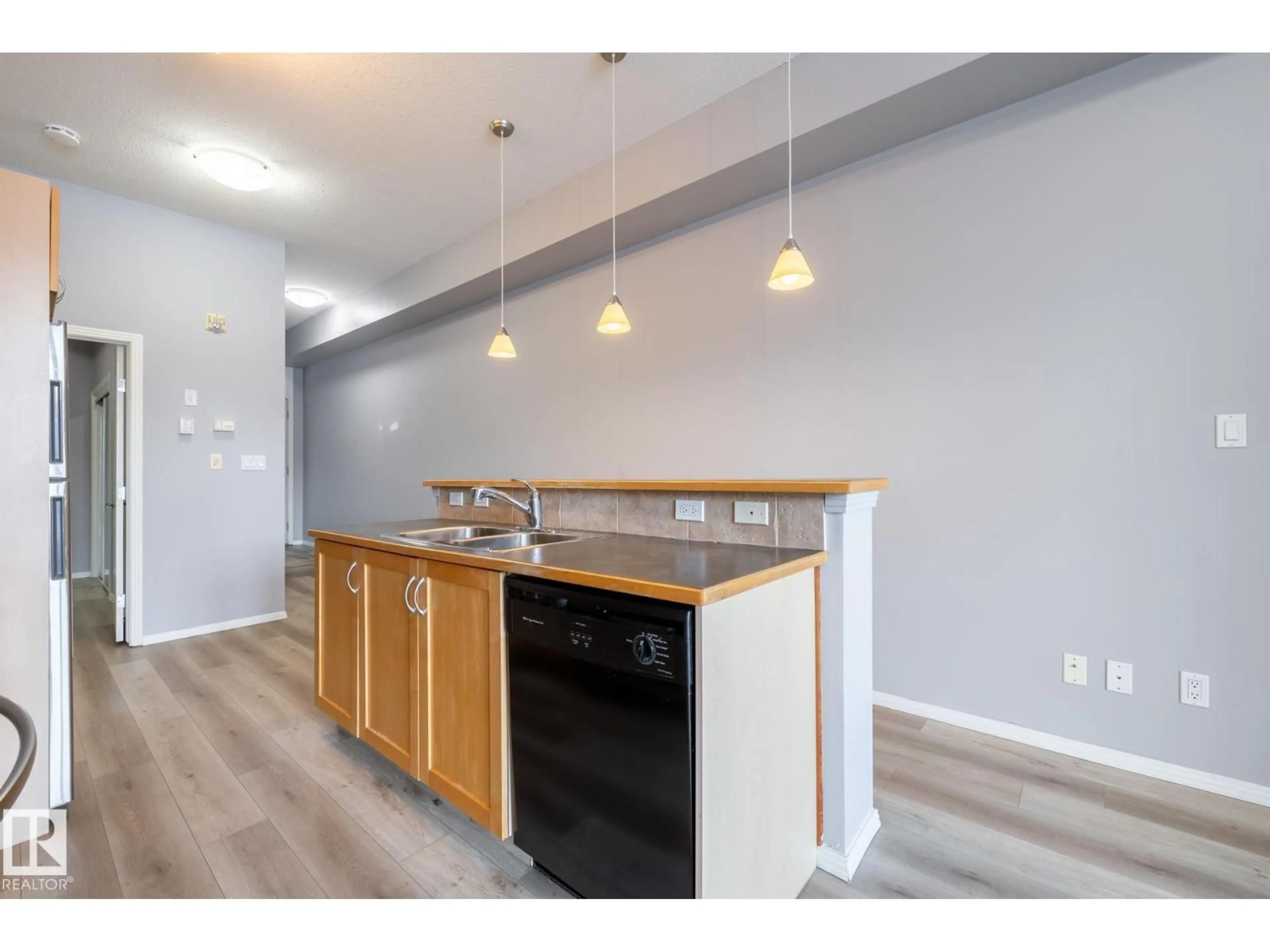Open concept kitchen, wood/laminate floor for #210 - 10147 112 ST, Edmonton Alberta T5K1M1