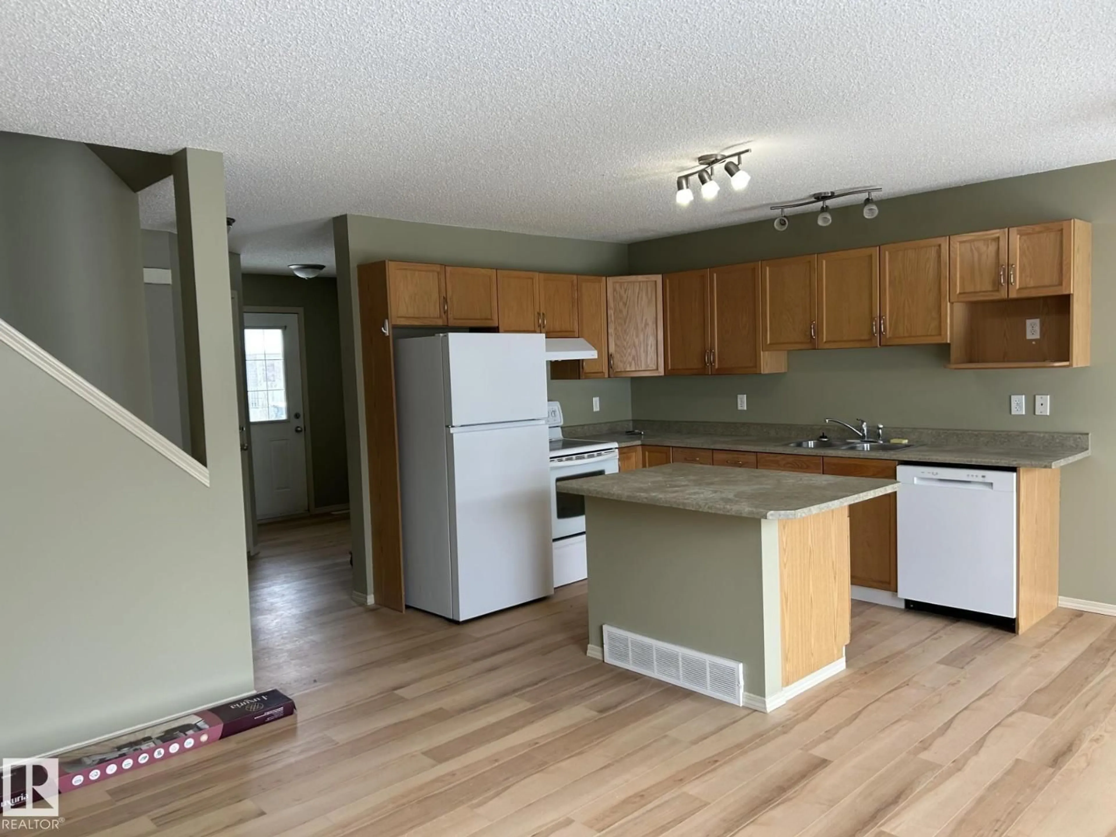 Open concept kitchen, wood/laminate floor for #112 - 4350 23 ST NW, Edmonton Alberta T6T1X8