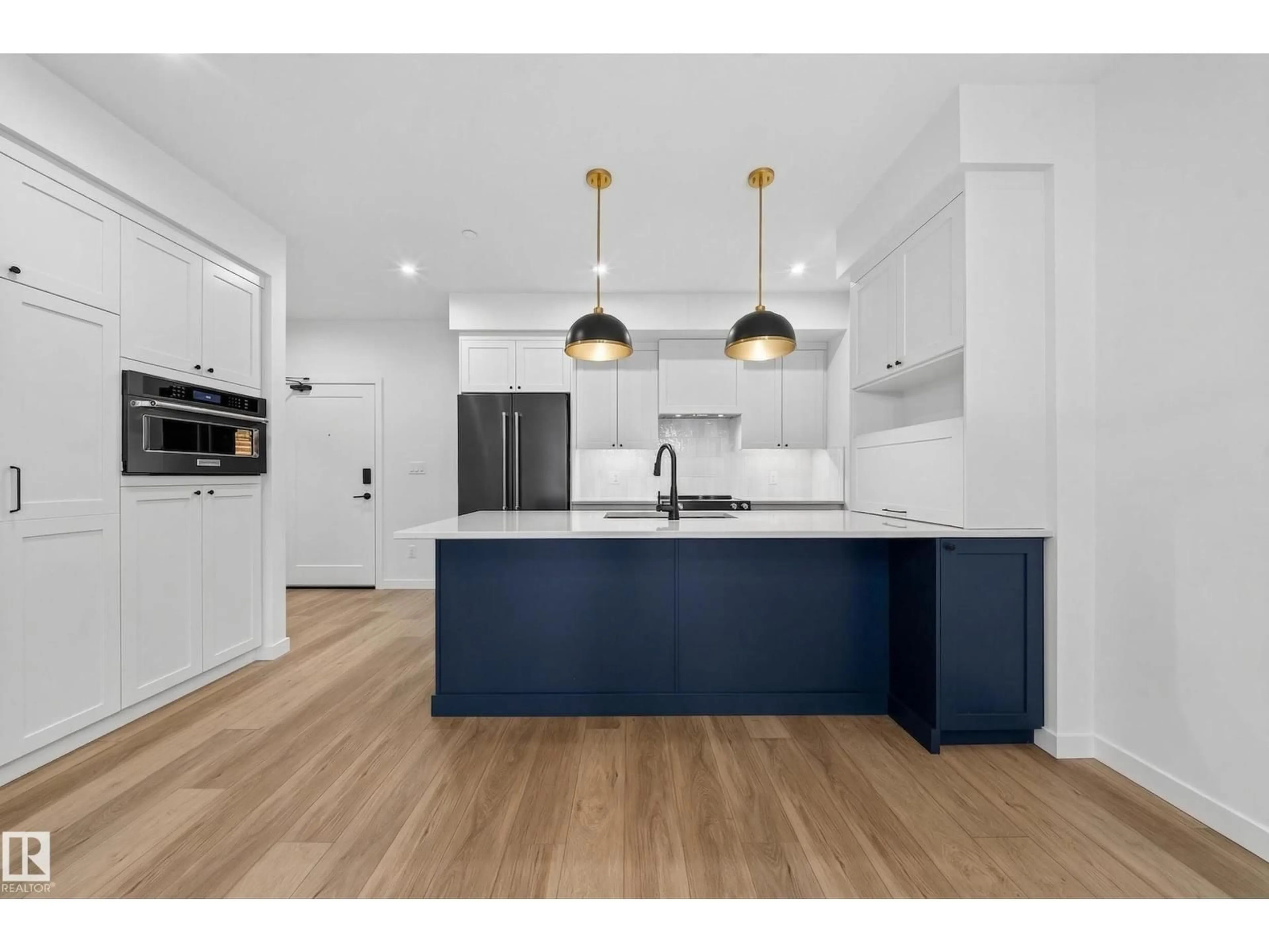 Open concept kitchen, wood/laminate floor for #301 - 7459 MAY CM, Edmonton Alberta T6R0X6