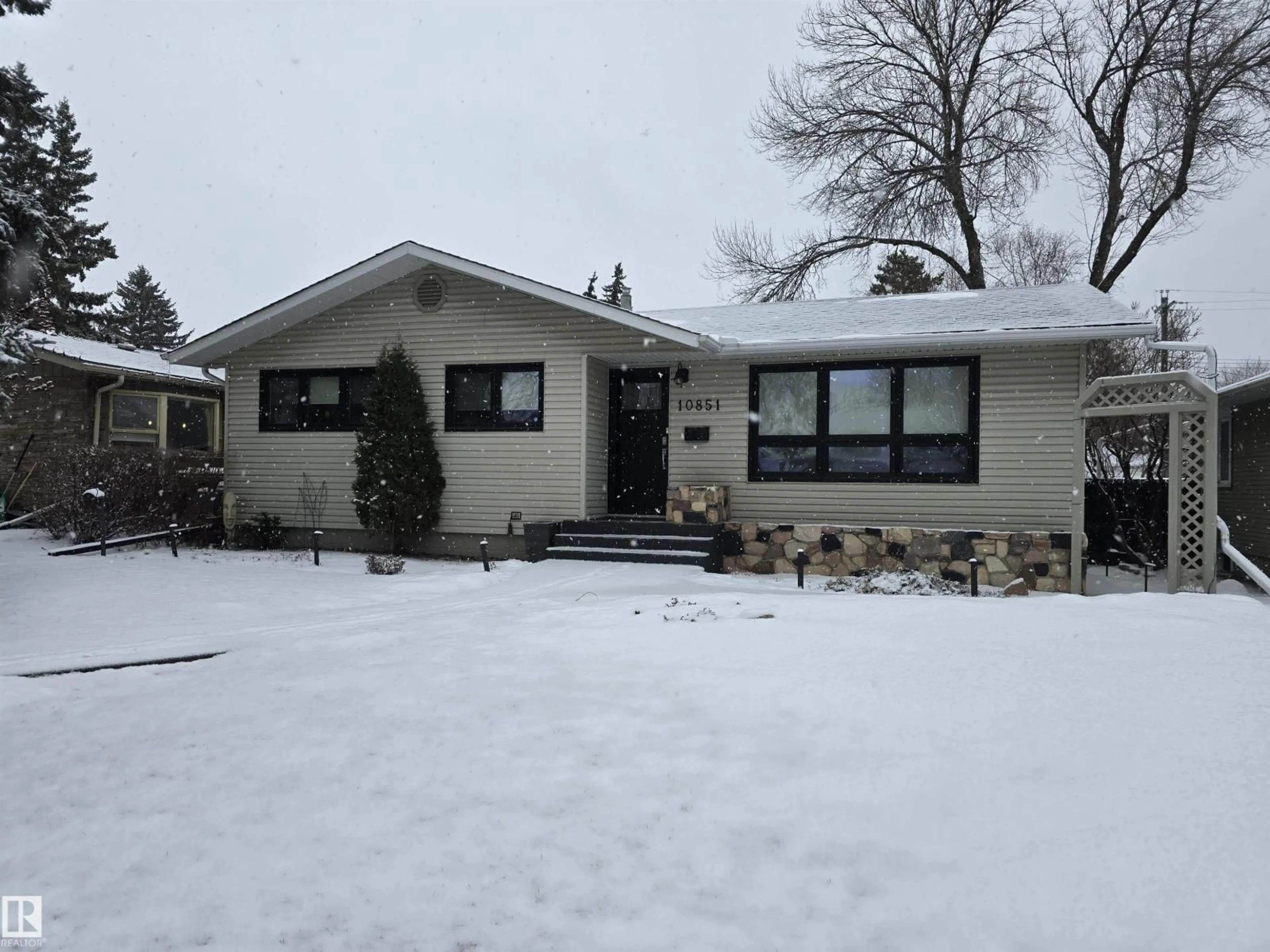Home with vinyl exterior material, street for NW - 10851 141 ST, Edmonton Alberta T5M1T3