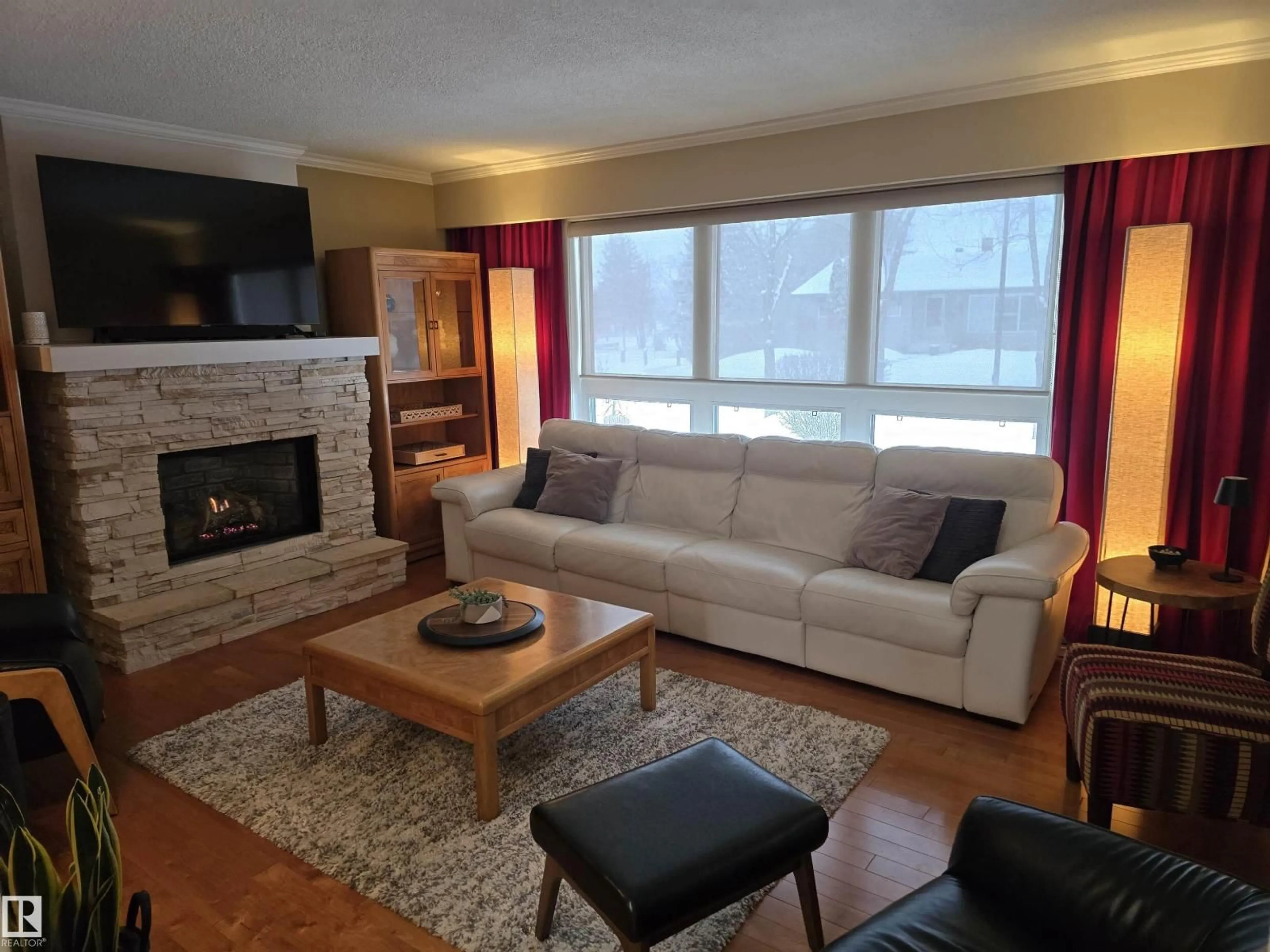Living room with furniture, wood/laminate floor for NW - 10851 141 ST, Edmonton Alberta T5M1T3