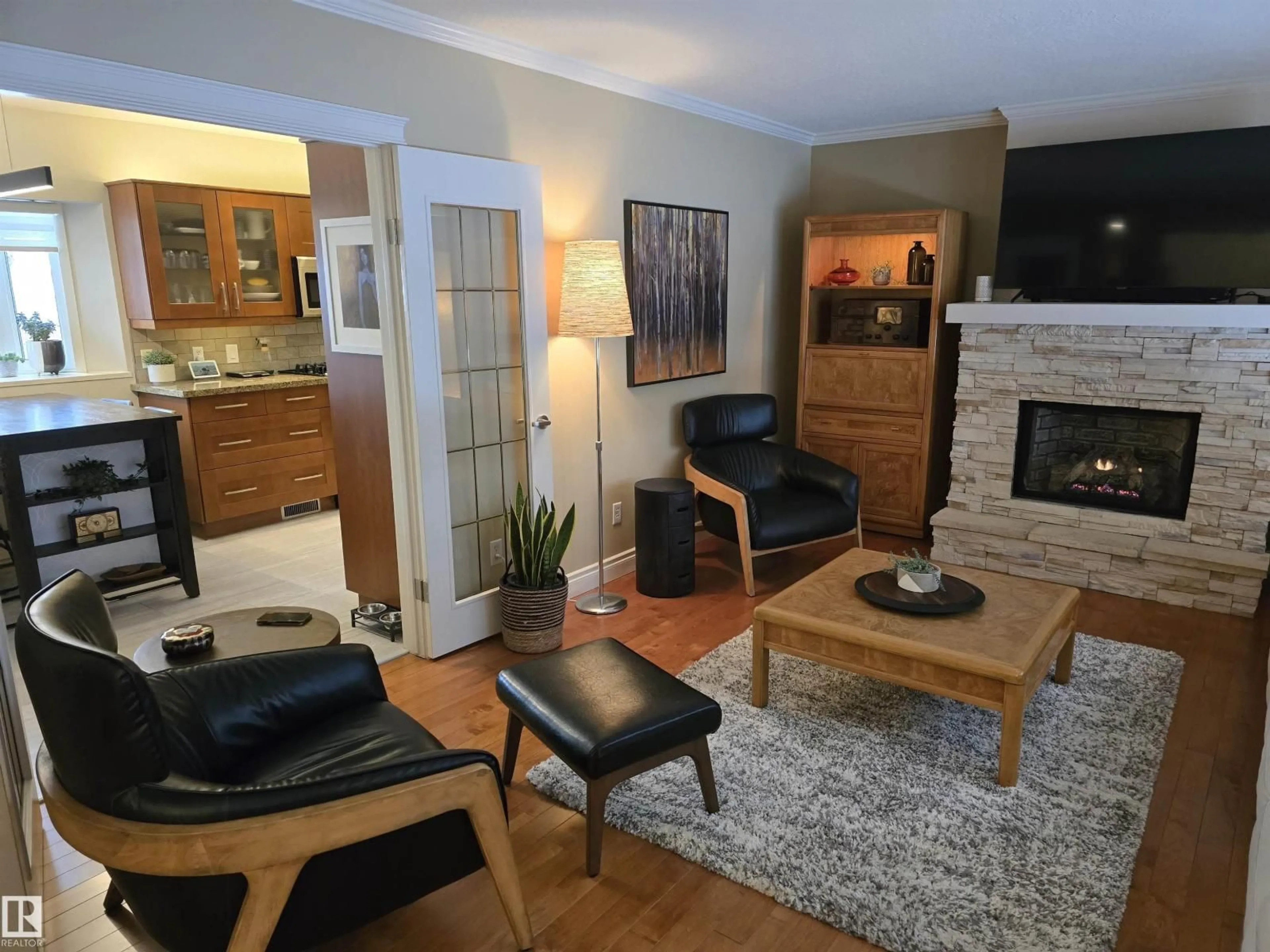 Living room with furniture, wood/laminate floor for NW - 10851 141 ST, Edmonton Alberta T5M1T3