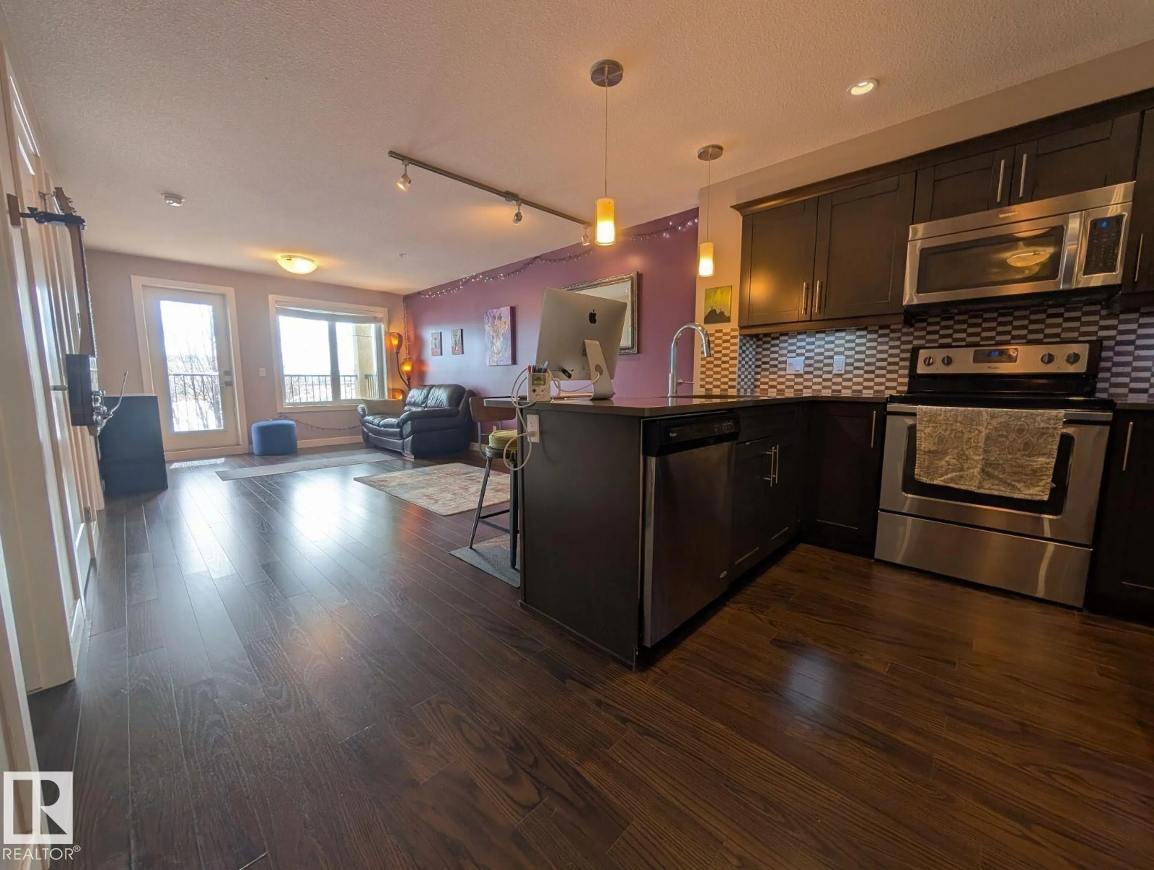 Open concept kitchen, wood/laminate floor for #208 - 1031 173 ST, Edmonton Alberta T6W3E4